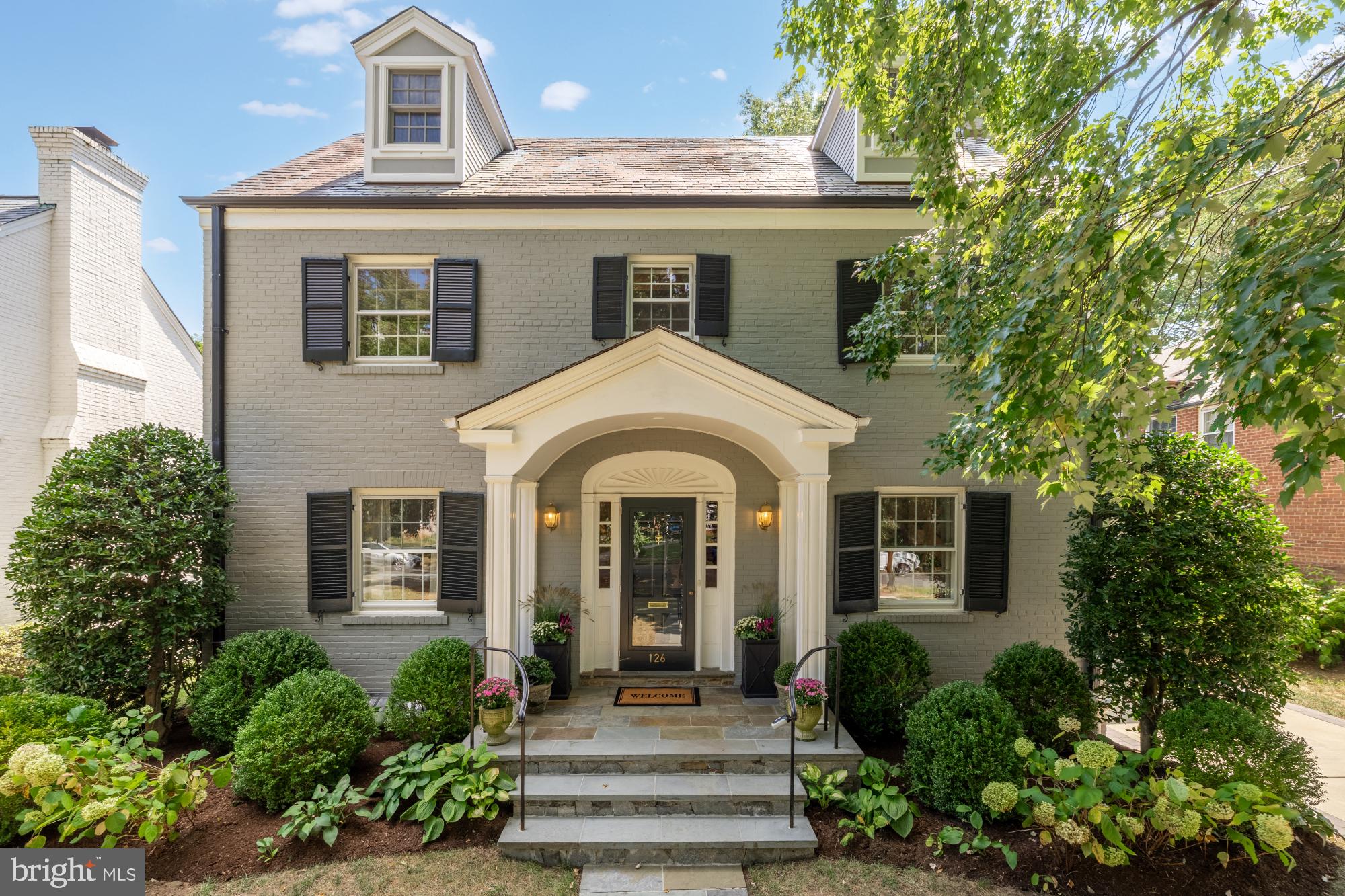 Quintessential Chevy Chase Village Living!
Welcome to Grafton Street, a stately Colonial residence in Chevy Chase Village, one of the region’s most admired neighborhoods, celebrated for its timeless streetscapes, gracious homes, and unmatched location. Just minutes from downtown Bethesda and Friendship Heights, this home offers effortless access to shopping, dining, retail, and nearby farmers markets. The location is truly prime, blending the quiet charm of the Village with the convenience of city living.
Inside, the main level flows with classic elegance and thoughtful design. At the front, a gracious formal living room with fireplace and an inviting dining room set the stage for entertaining. The chef’s kitchen anchors the center of the home with gas cooking, designer lighting, abundant storage, and a charming corner sink overlooking the garden. At the rear, a large sun-filled family room with fireplace opens seamlessly to the expansive deck creating an effortless connection between indoor and outdoor living. Mature landscaping with evergreen privacy screening, hydrangeas and a lush flat lawn make for truly the perfect backyard.
Back inside, a separate custom window seat, wrapped in southern exposure, provides a perfect nook for reading, relaxing, or soaking in the light. Everyday living is further elevated by a remarkably large mudroom, offering space for bikes, sports gear, and all of life’s essentials.
Upstairs, four true bedrooms include a serene primary suite with dual en suite baths - a rare and luxurious feature - plus a private balcony ideal for morning coffee. A recently upgraded hall bath with double vanity and laundry hook-up brings modern convenience.
Another floor up is a finished attic space which has been beautifully renovated, providing remarkable versatility: a fifth bedroom, home office, or wellness space complete with custom built-ins, two window seats, a handcrafted wood desk, and a full bath. On the lower level, a finished living area, additional full bath, laundry, and exterior entrance offer both comfort and future potential for even more finished space.
Situated within the Somerset Elementary, Westland Middle, and Bethesda - Chevy Chase High School cluster, this residence combines elegance, function, and location in one of the most admired addresses in the Washington area.
This home is more than a place to live - it is a rare opportunity to experience the essence of Chevy Chase Village living, where charm, sophistication, and community converge.