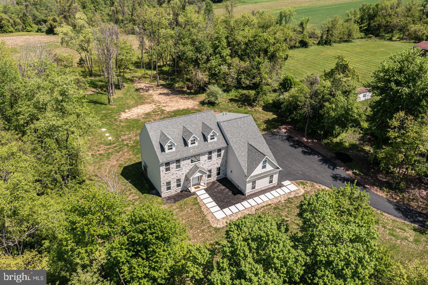 Wonderfully situated on almost 4.8 acres in beautiful Upper Makefield Twp! This one-year old home is nestled against preserved farm land with a great vista outside almost every window. Enjoy the benefits of an open concept with 10 ft ceilings, upgraded bathrooms, gorgeous designer kitchen featuring spacious island, stainless appliances, quartzite counters, and chic hardware. Spacious yet sustainable design with lots of versatility. 4 generously sized bedrooms including a main suite with wide plank white oak floors, fantastic walk in closets, a finished study or Sitting Room and large walk in closet, beautiful main bath showcasing a freestanding tub, enormous walk-in shower with rain head and bench seating. Additional sleeping quarters include a Guest Suite with full bath and 2 bedrooms that share a hall bath. Neutral, fresh pallet with wonderful storage, private lot backing to 100+ acres of preserved farmland in a convenient location, newly planted trees and sod. Council Rock schools and close proximity to everything.