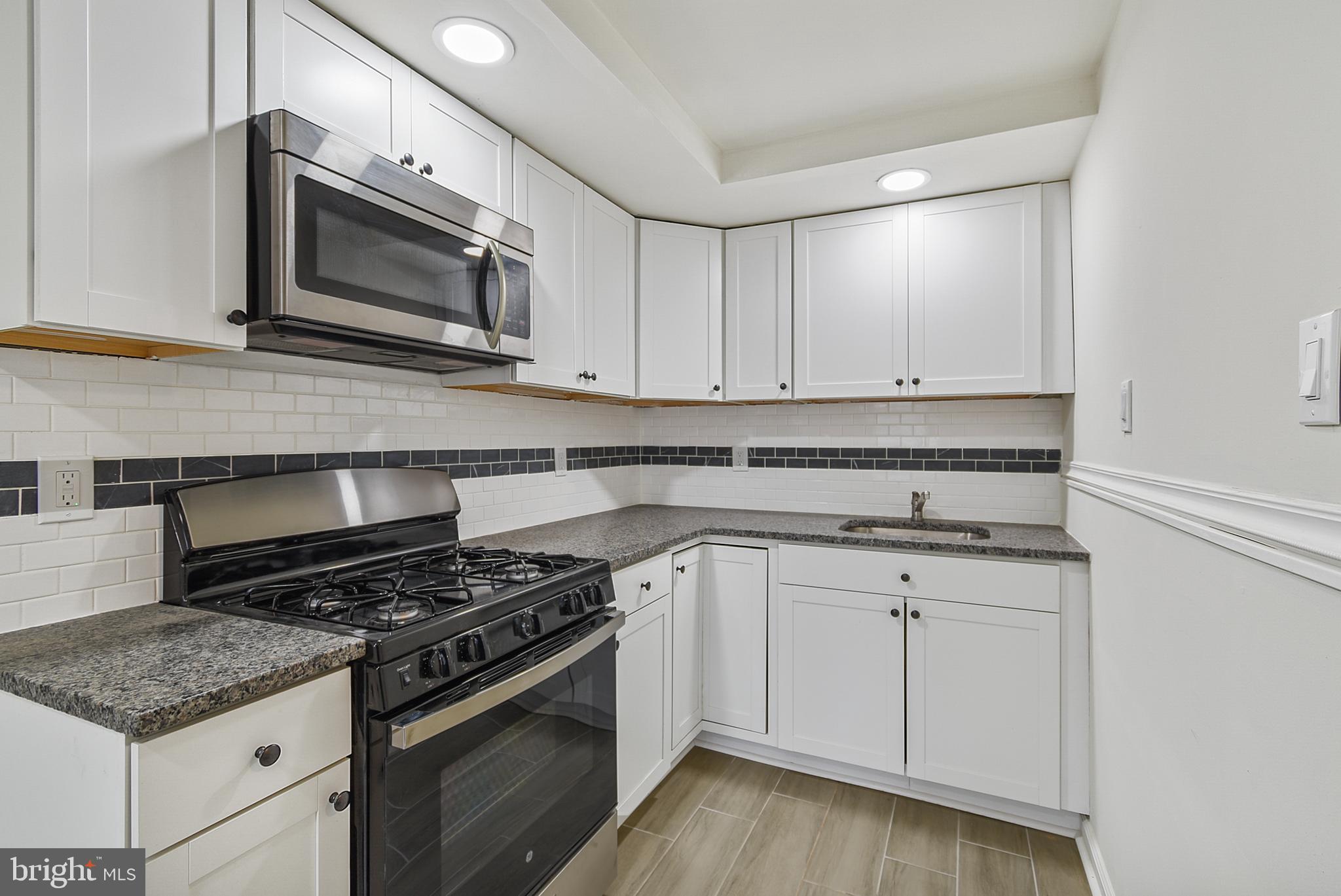 Welcome to 1246 Wycombe Ave, a beautifully updated interior row home nestled in the sought-after Lansdowne Park section of Darby. This 3-bedroom, 1-bathroom gem offers a perfect blend of modern updates and classic charm, making it an ideal choice for first-time buyers or anyone seeking comfortable living. Step inside to discover gleaming hardwood floors that flow throughout the main and upper levels. Freshly painted in neutral tones, the home is bright and inviting, ready for you to make it your own. The updated kitchen features durable tile plank flooring, white cabinetry, subway tile backsplash and stainless steel appliances, including a gas stove and microwave—perfect for preparing your favorite meals. The remodeled bathroom boasts a new tub with a stylish tile surround and a tiled floor, offering a spa-like retreat. Replacement windows throughout the home provide energy efficiency and added comfort. Enjoy the outdoors on the front patio and fenced-in front yard, ideal for your pup or for relaxing. A driveway offers convenient one-car parking out back. Additional highlights include washer/dryer hookups, a utility tub in the basement, and brand new forced-air gas heating. Don't miss your opportunity to own this move-in-ready home. Schedule your tour today! One of the owners is a licensed real estate salesperson in the state of Pennsylvania.