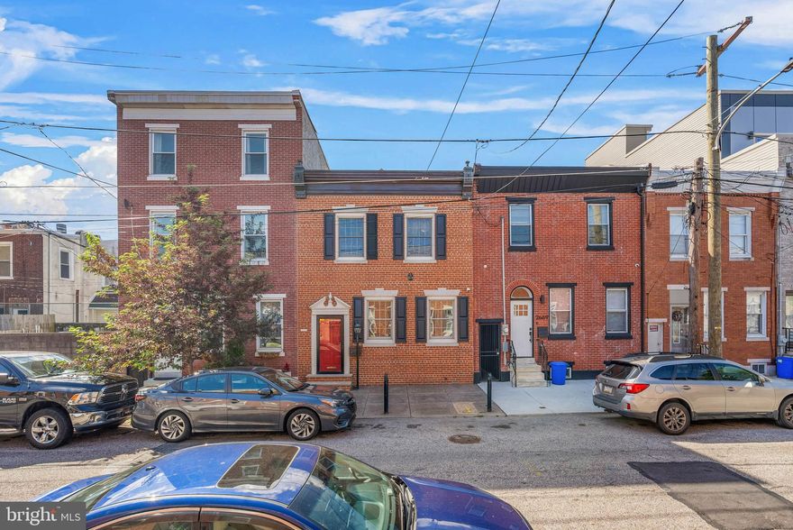 RARE OPPORTUNITY IN FISHTOWN – this unique, 4 bedroom, 2.5 bath, street to street townhome offers over 3,000 SF of living space and private 3-car parking. Unique features include 9-foot ceilings throughout, cherry hardwood floors, multiple skylights, and a chef’s kitchen with stainless steel appliances, Viking cooktop, double wall ovens, granite countertops and an oversized island. Just off the kitchen is a bright sunroom (can easily be converted to a mudroom) leading directly to a spacious, private rear patio and detached garage. The second floor offers a primary suite with walk-in closet, en-suite bath, and direct access to a former rooftop deck. Three additional bedrooms, a small office or extra closet, and a finished basement with laundry and storage complete the interior. The detached 3-car garage includes a finished second level with its very own central HVAC, water, and security—perfect for an office, studio, or guest space. No detail was overlooked at this house - new HVAC, tankless water heater, 200-amp electric, and underground utilities! Come see this masterpiece today.