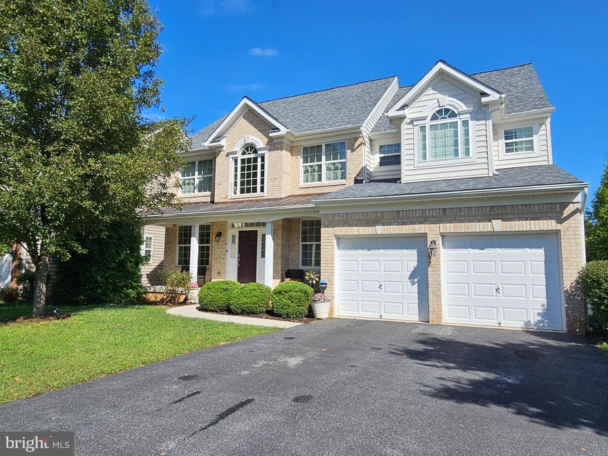 Welcome Home to this stunning customized brick 6 Bed 4.5 Bath boasting 5600 + Sq. ft. 1st floor main level living space.  This gem is unlike any other home in the development.  This colonial features an amazing open floor plan concept with 2 story high ceilings and cozy gas fireplace in the family room.  There is also custom built in book cases and shelves,  hickory hardwood flooring, additional windows for an abundance of natural light, recessed lighting, farmhouse shutters and many more unique touches.  The chef will love the gourmet Granite kitchen with island, gas cooking and many cabinets for storage space.  There are 2 dual sunrooms , formal dining room, sitting room and or office.  The upper level features 4 bedrooms with a large owners suite with tray cathedral coffered ceilings, his/her walk in closets and bathroom with dual vanities and soaking tub and sep. tile shower.  The owners suite also features a large alcove sitting room area.  There is a private guest suite and private bathroom.  The fully finished walk out level basement / rec. room has plenty of space for entertaining along with another bedroom and bathroom.  2 Car garage, party size deck with rod iron and large back yard makes this gem an amazing place to call home sweet home.  Roof is 4 Yrs - New HVAC - Community pool and amenities close to commuter routes and shopping.  This is a must see !!