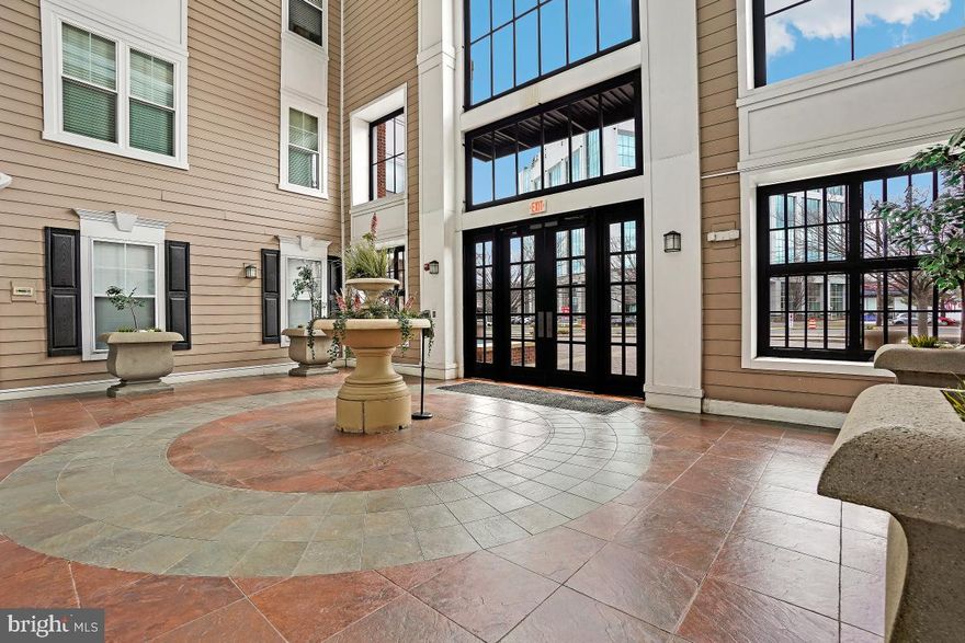 Absolutely Incredible, Renovated and Updated Spacious Condo with 9' Ceilings, and the Largest Balcony in the Complex Overlooking the Pool! Just blocks to Rockville Town Square and Rockville Metro! Located Extremely Close to the Only Elevator in the Building! Dual Owner's Suites with Walk-in Closets and On-Suite Baths! French Doors Lead to Largest, Extended Balcony with Best Views in the Complex. Updated Kitchen with Stainless Steel Appliances including New Gas 5-Burner Range, New Upgraded Top-Control Dishwasher, Stainless Range Hood, and White Quartz Counters with Breakfast Bar. Kitchen Leads to Open-Concept Dining and Living Room with Gas Burning Fireplace, leading to French Doors which Open to the Largest Balcony in the Building with Best Views in the Complex. Condo features Large Laundry Room with Additional Storage. Recently replaced HVAC. Condo fee Includes Dedicated Internet, Cable, Amazing Amenities such as Outdoor Pool with Lounge Chairs and Grill, Theater, Cyber Café, Exercise Room, Courtyard and More! Dedicated Garage Parking. "Other fee" listed is replacement reserves.