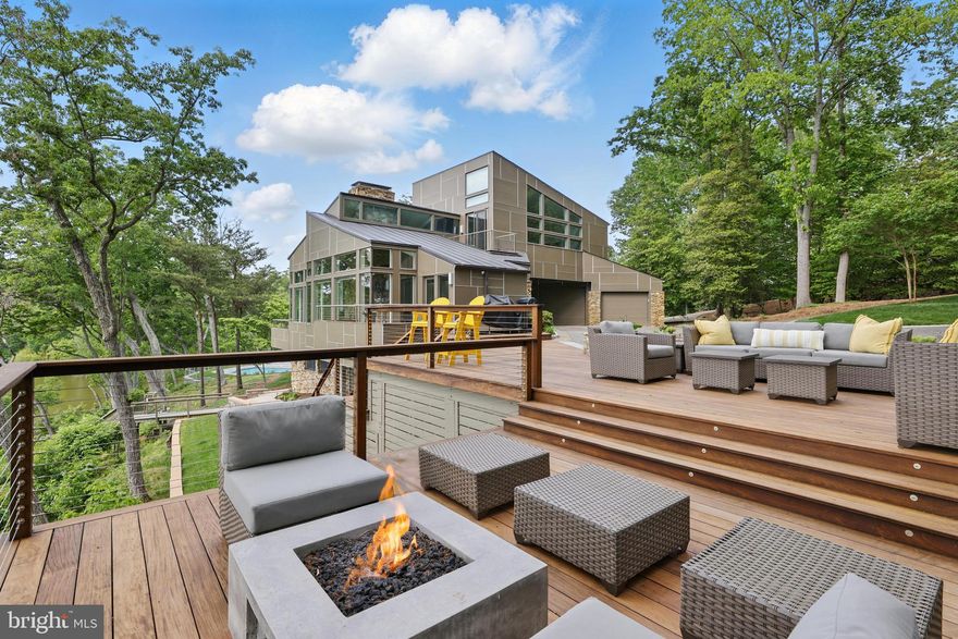 Luxury Waterfront home in sought-after Glen Oban. Mere minutes to Annapolis by car or boat! This exceptional waterfront residence embodies modern elegance and unparalleled comfort. Thoughtfully designed to showcase its stunning surroundings, the home features an open floor plan with expansive windows, flooding each room with natural light and offering spectacular views of the Severn River and Asquith Creek. With over 4,600 sq ft of meticulously crafted living space, the home boasts soaring ceilings, refined finishes, and a seamless blend of style and functionality. From the chef-inspired gourmet kitchen to the serene primary suite with a private deck, every detail has been curated for both relaxation and entertainment. A welcoming entrance opens into a light-filled floor plan designed to highlight stunning water views from every angle. The spacious living and dining areas feature soaring ceilings, expansive windows, and seamless access to the outdoors, providing an effortless flow for entertaining. The gourmet kitchen is a chef’s dream, complete with high-end appliances, custom cabinetry, and an oversized island, all strategically placed to capture panoramic views of the Severn River. Outside, the 1.53-acre cul-de-sac lot offers a true waterfront lifestyle of 323 feet of waterfrontage and a tram leading to a 90' pier, multiple lifts, and space for a large yacht, complemented by community amenities like a pool, tennis court, and tot lot.  Excellent location for commuting with easy access to the Bay Bridge, Rt 2, 50, 97, that provides direct access to Baltimore, BWI, Ft. Meade/NSA and Washington, DC.! Attractive destinations such as the Annapolis Harbor, Baltimore's Inner Harbor, St. Michaels, Oxford, and Solomon's Island are only a cruise away. Explore the many local shops,  restaurants, doctors/medical offices, and the Naval Academy minutes from your door. This is more than a home – it’s an extraordinary living experience in a breathtaking setting.