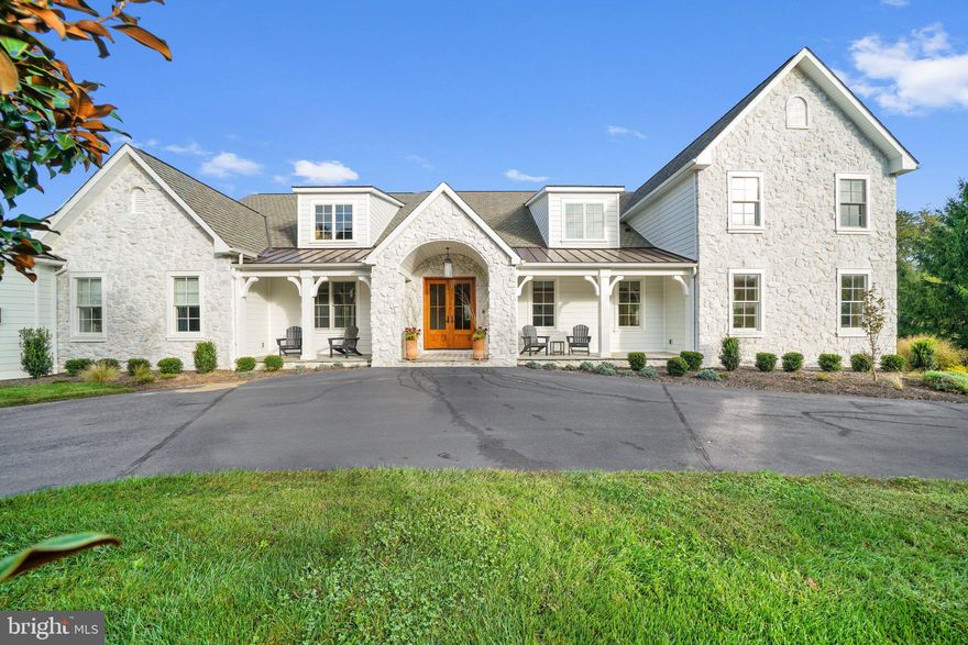Originally built in 2002 by builder Jeff Berlin, this home has been thoughtfully and wonderfully reimagined into a modern French country-style home by the current homeowners. The home is situated on 2.28 acres of land within the desirable township of Chadds Ford and in the award-winning Unionville-Chadds Ford School District. The home has had a complete renovation inside and out, removing all stucco, every door, window, floor, cabinet, appliance, and all drywall to create a much more open floor plan. The square footage now encompasses 10,500 and includes 7 bedrooms and 4 and a half baths. This home was awarded 2022 Best In PA Living & 2022 Best Architectural House/Renovation Private Residence, Chadds Ford By Home Builders Association of Chester/Delaware/Bucks And Montgomery Counties.
The home features new siding and stone facade and as you approach the new double front door you enter the grand foyer and immediately admire the elegantly curved stairway and hardwood floors that run throughout the home. The first floor has a new gourmet kitchen, complete with stone wall backsplash, granite countertops, new cabinets, a large island, new double oven and cooktop, and more. Adjacent to the kitchen is a separate new butler's pantry with cabinets, sink, new refrigerator, and extra counter space for storage or preparation for entertaining and holiday dinners. The separate eating area features glass doors leading to serene views for those peaceful starry nights and an updated patio with fireplace, grill, and more. The entire home has been updated with wide plank hardwood floors and new light fixtures and the first floor was updated with new exposed wooden beams to the ceilings in most rooms keeping with the updated modern French country style. The home was opened up into an open floor plan that now features a formal living room with fireplace, a sitting room, and great room adjacent to the kitchen with a gas fireplace, and a formal dining room. The first-floor in-law suite has been updated with a new full bathroom and the original open-air breezeway to the garage has been closed in to add even more charm as you progress onward to the garage. The detached three-car extended garage provides plenty of parking with a second driveway providing extra parking space. The space above the garage has been finished being creatively turned into a yoga studio. The split rail fenced grounds to the right of the house are part of the property and could be used for your pets/tennis/pool etc. Mixed landscaping with mature trees and open space surrounds this one-of-a-kind spacious home complete with an expansive horseshoe driveway that screams luxury at its finest. The elegant curved staircase leads to the second-floor grand double-door entrance of the stately owner's suite. A tray ceiling adds to the splendor of the large, spacious bedroom. The new owners updated the bathroom perfectly, updated the sitting room and closet by opening them up into one space, and added a coffee bar to make this the perfect owner's suite. There are 3 additional bedrooms, one Jack & Jill shared bath (all wonderfully updated) along with 2 unfinished rooms/attic spaces, accessible from the hallway, that could be finished for an additional bedroom/office/gym/extra living space. The new owners added a much-needed cedar closet and a laundry room adjacent to the owner's suite. Finishing the design of this well-built custom home is a walk-out basement with 10-foot ceilings. The basement, totaling approx. 3572 sq. ft. has been lovingly transformed into a finished space with another bedroom that has two loft beds and two other beds below making it the perfect kids' room. There is a full bathroom on this level, a full bar, two areas for playrooms or formal sitting areas, a living room, and a wine cellar. This home is a must-see, with picture-perfect views, and is the perfect place for someone who loves to entertain. There is an easement for common driveway maintenance.
