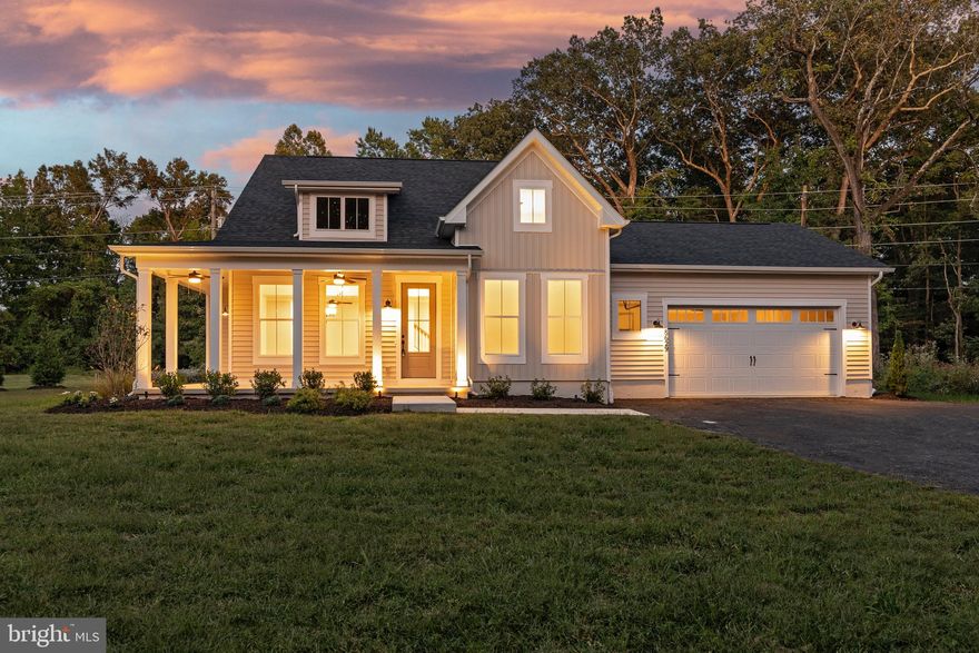 For buyers seeking a quicker move-in, the same model is currently under construction less than a mile away and will be completed in approximately 30 days, offering the perfect opportunity to preview the craftsmanship and finishes in person or purchase if a faster timeline is preferred.
This to-be-built Modern Farmhouse by local builder Laine Street Homes blends timeless architecture with modern luxury. Spanning over 2,200 square feet, the home features a main-level owner’s suite and high-end appointments throughout. Step inside to an inviting open-concept main level that includes a spacious family room with gas fireplace, a formal office with cathedral ceiling, a morning room nook, dining area, and a convenient half bath.
The gourmet kitchen is a true showpiece, featuring a large center island with breakfast bar, soft-close shaker cabinetry, open apron farmhouse sink, quartz countertops, subway tile backsplash, and a five-piece stainless steel appliance package including a wall oven, cooktop, and range hood. The main-level owner’s suite offers a walk-in closet and a luxury ensuite bath with dual vanities and an expansive 7x6 spa shower with dual shower heads. Upstairs, you’ll find two additional bedrooms and a second full bath.
Additional highlights include LVP flooring throughout the main level, ceramic tile in all baths and the laundry room, public sewer, 30-year architectural shingles, a 92% efficient Carrier HVAC system, 2x6 framing, R49 ceiling insulation, R21 wall insulation, and an air seal package. Outdoor spaces include a 246 square foot paver patio and a spacious wrap-around front porch. With no HOA or restrictive covenants, this home offers rare flexibility and freedom in a highly desirable Anne Arundel County location, convenient to both Annapolis and Washington, D.C.