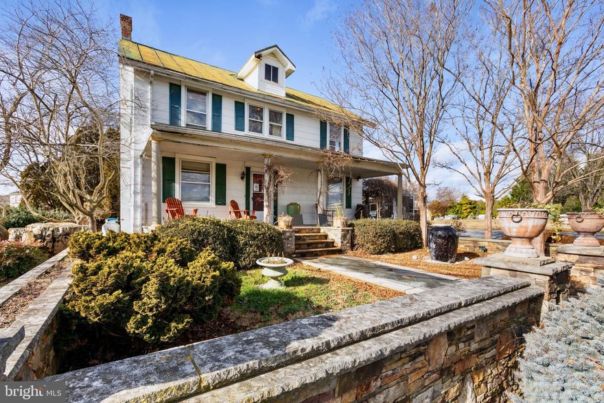 This property is currently being utilized as commercial.

1900-built home on 1 acre of land offers a blend of timeless charm, modern comfort, and potential for personalization, making it a unique and desirable property for those seeking a piece of history with room to make it their own.

The exterior of the home showcases traditional architectural features that are characteristic of homes from the early 20th century, including a charming front porch and classic siding.  Adding to the charm is a beautiful stone retaining wall and columns, a slate walkway to the front porch, and stone stairs up to the front porch.  A beautiful stone patio is the perfect place to enjoy the outdoors.  Mature trees and landscaping enhance the overall curb appeal and offer shade and privacy.

As you enter the home, you are greeted by beautiful hardwood floors that run throughout the main level.  The living room exudes warmth and comfort, with a wood burning fireplace, ample natural light, and a cozy atmosphere.  The welcoming dining room is perfect for family gatherings and entertaining guests.  A convenient mudroom located just off the kitchen provides space for storing outdoor gear and shoes, helping to keep the main living areas tidy.  The main level also includes a laundry room, and a half bathroom.

The upper-level features three bedrooms, each with its own unique character and hardwood flooring.  A full bathroom on this level serves the bedrooms and is complete with modern fixtures and amenities.
The property includes a full, unfinished basement, offering endless potential for storage or customization to suit your needs.