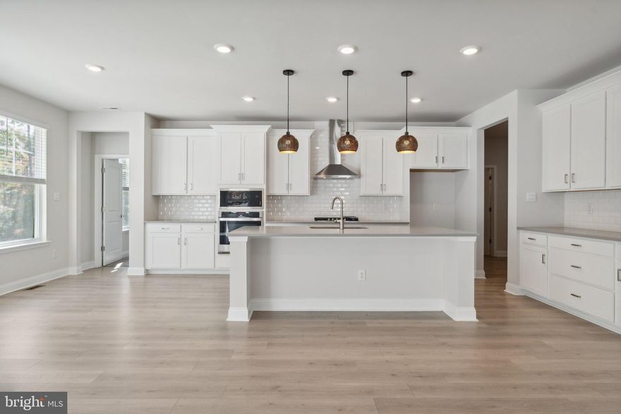 This Hampton floorplan offers 7BR and 6.5 BA in 5,943 sq. ft. A grand entrance into the 2 story foyer showcases a flex room and formal dining room. Continue walking into your spacious great room including a cozy gas fireplace open to a chef's kitchen with quartz countertops, soft close shaker cabinets, gas cooktop, stainless steel built in microwave oven, and generous pantry. Also available on the first floor is a guest BD with en-suite BA. Continue up the oak staircase to the second floor featuring 4 secondary BR, one jack and jill bath, and 2 additional full BA. Also on the 2nd floor you have the luxury primary suite featuring his and her walk in closets in addition to a separate soaking tub and glass enclosed shower. The fully finished basement including wet bar, 1 BR, a full BA, a 665 sq. ft. fully finished rec room, and unfinished storage space. There will be a 12 x 20 deck overlooking the backyard as well. The house is ready for its new owner!