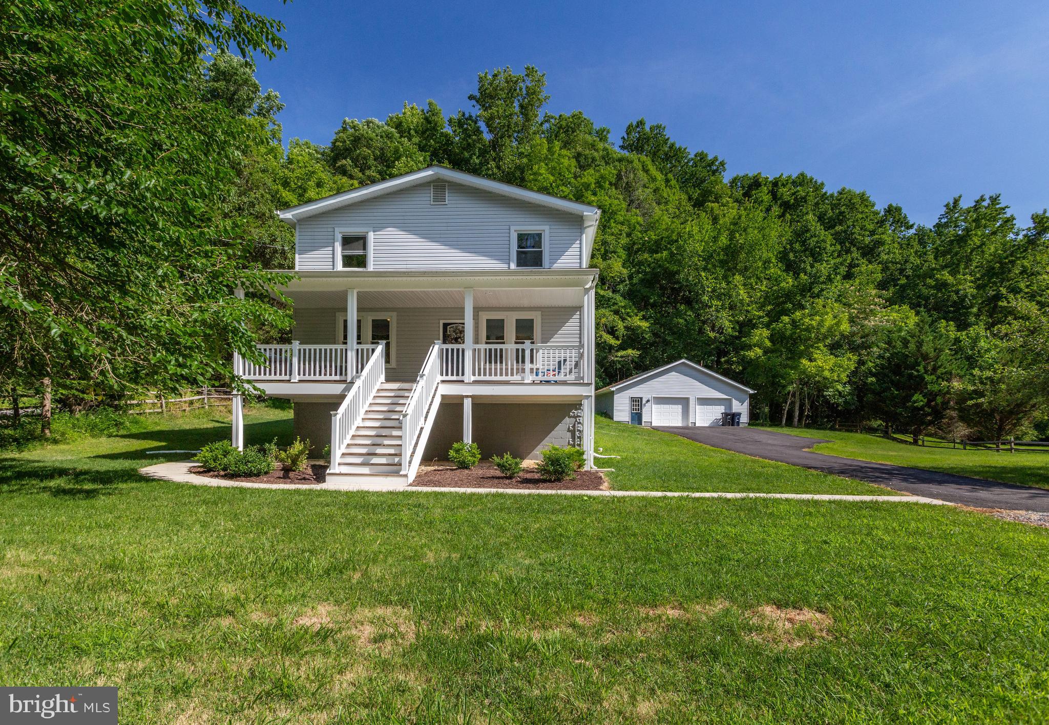DO NOT MISS this extraordinary HGTV-inspired home! Expansive & charming front porch welcomes you to this fully rennovated stunner with all new electrical & plumbing, windows, roof, flooring, lighting, etc. Wide-plank, distressed hardwoods throughout main level. OPEN concept with dining room, great room that opens to large kitchen with granite counter tops, all stainless appliances & 42" cabinets! Mudroom off back door leads to huge laundry room with loads of storage space. Proceed to upper level to find 5 bedrooms, linen closet and large bathroom with contemporary wide-tile flooring and granite countertops. Stairs to lower level finished, and open to huge walk-out basement ready for a recreation room or more living space! Backs to woods with trees and privacy! Land across the front of home will not be developed, to create secluded living!