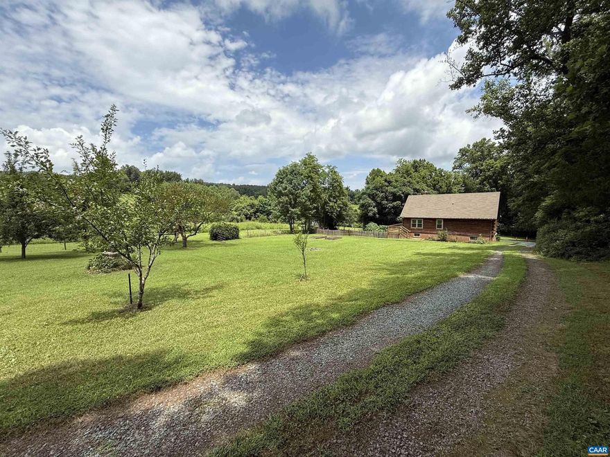Discover the perfect fusion of rustic charm & modern comfort in this remodeled log cabin, nestled on 6.15 acres of permaculture-designed land w/ mature fruit-bearing trees, grapevines & perennial flowers. Just minutes from downtown Cville. Contemporary updates include high-efficiency double-pane windows, new washer & dryer, a smart home thermostat & Blink cameras. Upstairs living area boasts solid wood floors & spacious open-plan design w/ soaring ceilings, a wood-burning fireplace, & picture window w/ views of the adjacent vineyard. The renovated kitchen has solid maple soft-close cabinets, gorgeous granite countertops, newer appliances. Downstairs additional living space offers third bedroom, full bath, common room & laundry room w/ tile flooring throughout. Large wrap-around porch & outdoor shower. Gently flowing creek meanders through the property rear, leading to a secluded glade. The expansive grounds are ideal for micro-farming, raising animals, or simply enjoying the tranquility of the land. With no light pollution, the night skies are spectacular for stargazing. Rare offering provides the ultimate blend of comfort & sustainability for those seeking private retreat, hobby farm, or lifestyle property with room to grow.,Granite Counter,Maple Cabinets,Fireplace in Family Room