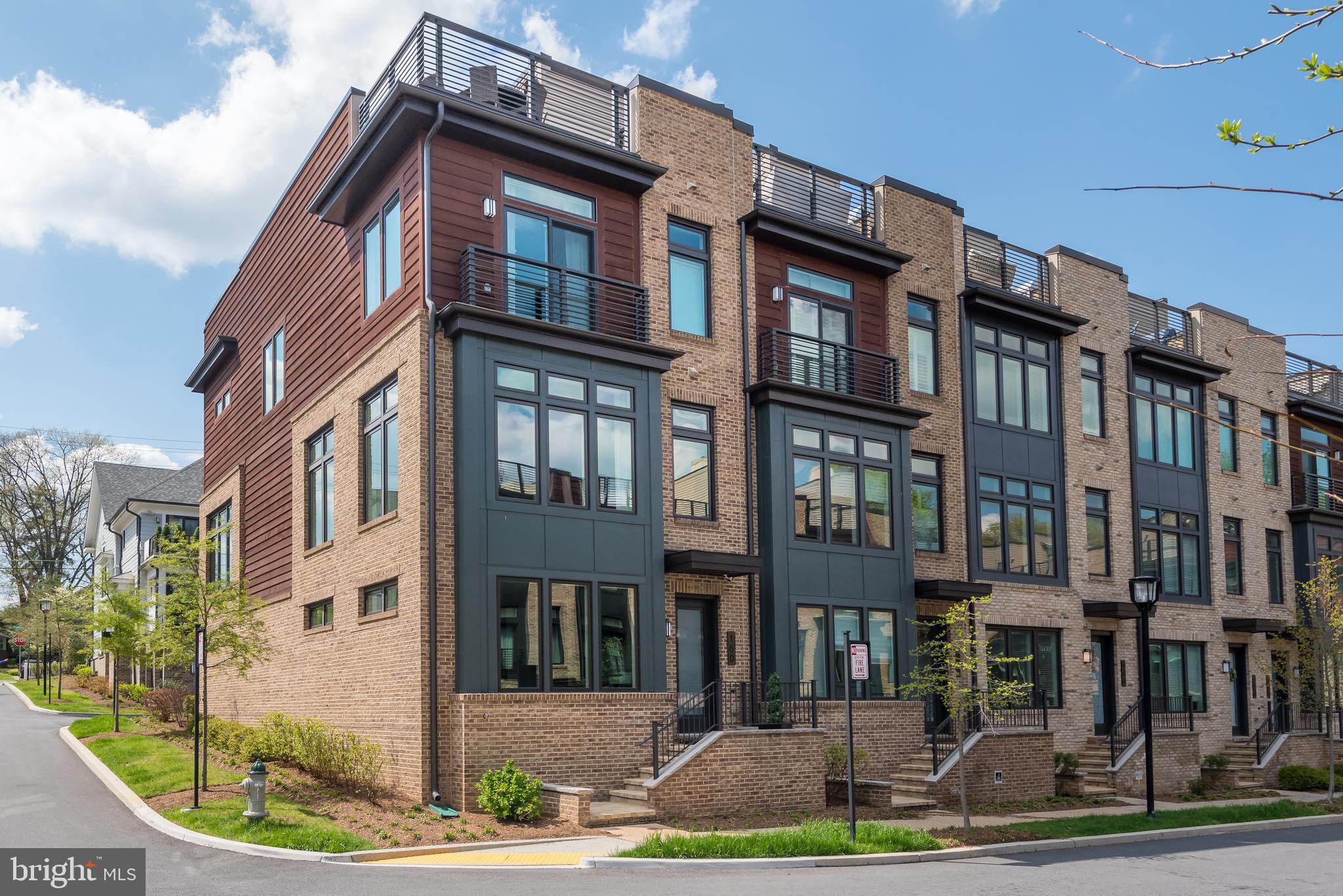 ****NEW PRICE FOR THIS BEAUTIFUL MODEL HOME!!!*** Have you been searching for a luxury townhouse that is situated in a great location? If so, you are going to love this 4 Bedroom 3.5 Bathroom end unit contemporary elevator townhouse! Welcome to Grosvenor Heights where Luxury converges with location in a tranquil 33-acre wooded community situated in what was part of the Grosvenor Estate. Easily accessible to Wildwood Shopping Center, Grosvenor Strathmore Metro, Fleming Park, Rock Creek Park, Bethesda Trolley Trail and all major commuting routes being just minutes away! The entry level has a comfortable multi-generational suite with a kitchenette having elevator access to all floors in the home including the expansive rooftop terrace. 10ft ceilings combined with floor to ceiling windows on the front, rear, and side of the main level provide an abundance of light that is uncommon in townhomes. The modern kitchen is simply elegant having white quartz countertops with waterfall edges on the large island that seats 4. Subway tile backsplash in a herringbone pattern, designer cabinets, pendant lights, an integrated subzero refrigerator topped off with stainless Bosch appliances. Relax by the gas fireplace in the family room that walks out to a large deck on the main level! Meaning, outside dining near the kitchen without having to go to the rooftop! The bedroom level has the owner’s suite plus two large bedrooms along with another bathroom and a separate laundry room. The sun filled owner’s suite has two closets and a spectacular ensuite bathroom. The expansive rooftop terrace is accessible from the elevator and features Brazilian hardwood deck tiles, retractable awning, large stainless kitchenette, Viking refrigerator, space for a TV, and a gas grill built into a stone veneer grill station with plenty of countertop space to use when cooking. So many thoughtful choices were made with this Leed Certified home; Cedar Trim and brick to blend in with surrounding natural environment, Hardwoods throughout, custom chandelier, Sonos Sound System, Floor to ceiling drapes with custom edges, motorized window treatments, storage racks in the 2-car garage and much more. WATCH 3D TOUR HERE -