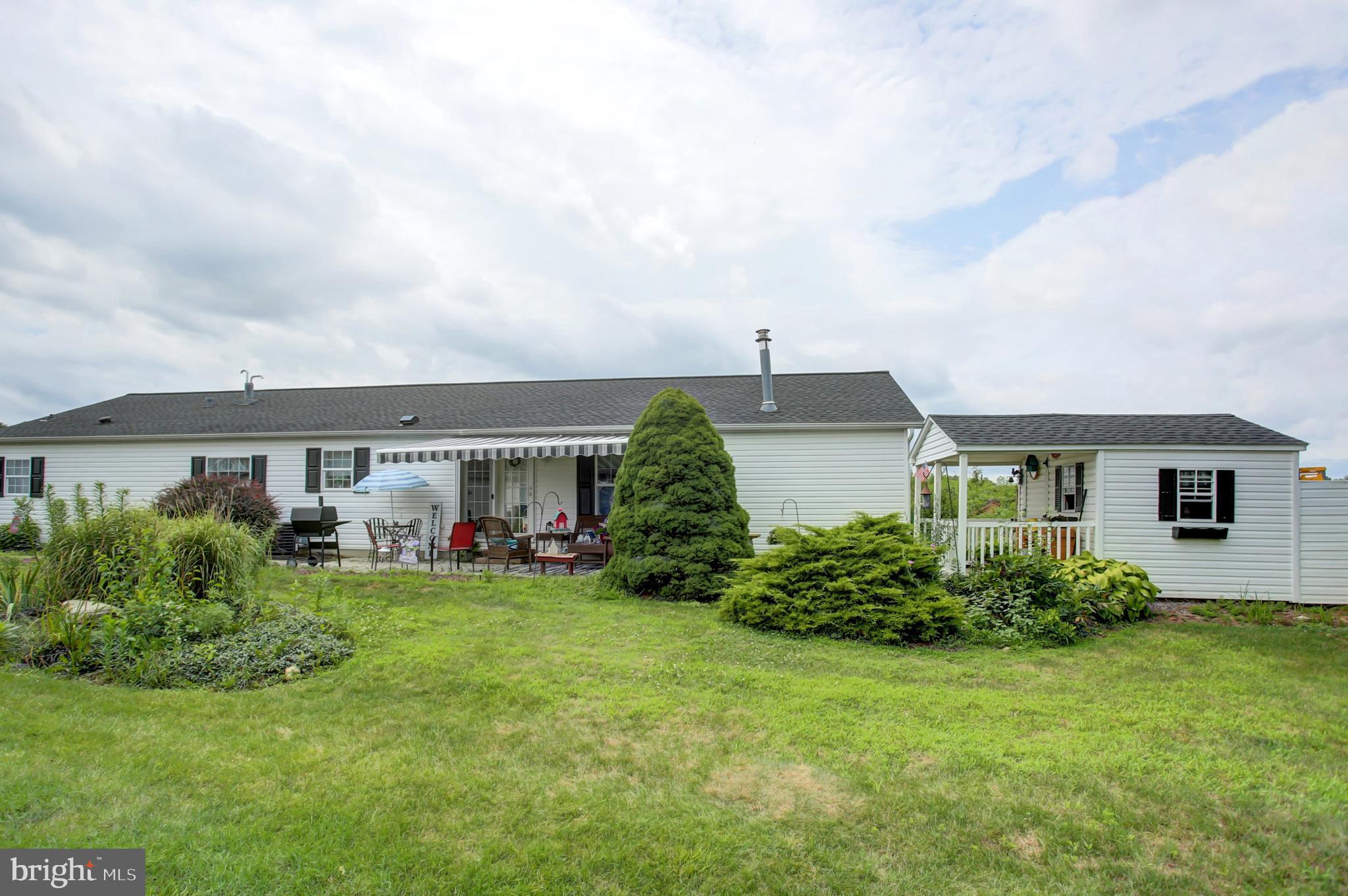 Embrace low-maintenance luxury in this beautifully designed manufactured ranch home, offering 2,128 square feet of spacious living within the vibrant Shippensburg Village 55+ adult community. This 3-bedroom, 2-bath residence blends comfort and style, featuring a bright living room, a cozy family room with a stone gas fireplace, and a dedicated office for work or hobbies. The primary suite is a true retreat, boasting a large walk-in closet and a luxurious bath with a soaking tub, separate shower, and dual-sink vanity. The expansive kitchen, complete with a central island, flows seamlessly into formal and informal dining areas, ideal for entertaining or everyday meals. A separate laundry room adds convenience, while the inviting side patio with an awning and a large shed with a covered porch provide ample outdoor space for relaxation and storage. The monthly community fee of $288 includes your sewer, trash, and with optional lawn and snow care included with your monthly rent for $42 more, you can spend less time on outdoor chores and more time doing what you love. Enjoy the best of 55+ living in this thoughtfully designed home, perfect for your next chapter!