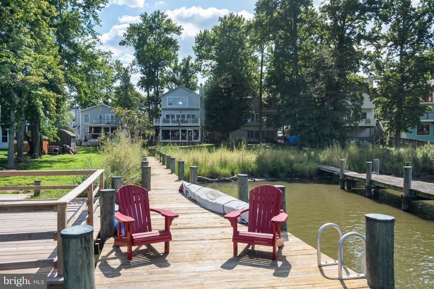 Phenomenal water front home on Oyster Creek with chic renovation&private dock!Exceptional views, light & airy, easy living home.Atrium doors to big deck from great rm w/cozy woodburning fire place,custom built-in & excellent privacy.To-die-for master features great bath,walk-in closet & outstanding views.Screened porch to flat fenced .20 arce yd. Short stroll to sandy community beach.Won't Last!