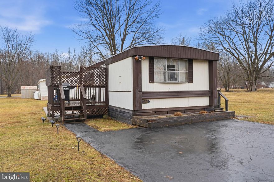 Come see this expanded 2-bedroom, 1 bath home in Colonial Heritage, situated on a corner lot just minutes away from the center of all that Doylestown offers walk and bike trails, shopping, and restaurants. Walk through the front door and you will be greeted with a spacious living room/dining room area. The large windows in the front of the home provide plenty of natural light. The kitchen features ample cabinet space, island seating, and a pantry. Adjacent to the kitchen is a family room with a propane gas fireplace. The master bedroom is a nice size with a large closet, and access to the full bath with double sinks and a walk-in shower. An additional bedroom and a laundry closet in the hallway complete this home. Outside, you will find a shed, two parking spaces, a private deck, and a patio area. This home is ready for the next buyer to restore its beauty.
