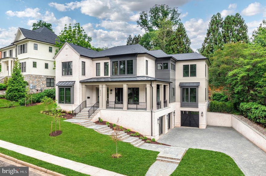Now completed in Country Club Hills, Arlington’s premier neighborhood just minutes from Washington Golf & Country Club and Washington, DC, 4653 34th Street N represents a rare opportunity to own a new custom residence built by best-in-class design build firm, Classic Cottages.  Thoughtfully conceived for modern living, this 6-bedroom, 6-full bath and 2-half bath home offers the scale, quality, and quiet sophistication that discerning buyers spend years looking for — complete with a private elevator serving all three levels, a wraparound front porch, and a custom gunite plunge pool set within a beautifully landscaped .31-acre lot.

From the moment you step inside, the craftsmanship is unmistakable. Soaring 10-foot ceilings, 7.5in wide-plank white oak wood floors across every level, solid-core doors, extensive custom millwork and design detail, and a whole-home sound system establish an elevated and enduring standard of finish.  

The main level is ideally designed for daily living, special gatherings, or impromptu get togethers. A private office offers a quiet space to retreat and focus, while the dining room flows naturally into a fully equipped butler's pantry — with wine cooler, ice maker, and secondary dishwasher — and a hidden scullery that keeps the kitchen composed and organized no matter the occasion. The kitchen is exactly what serious cooks and gracious hosts demand: custom inset cabinetry, 3cm quartz countertops, a generous island, pot filler, and a Wolf and Sub-Zero appliance suite. The great room — anchored by a gas fireplace with stone surround — opens to a screened porch with integrated heaters, making the transition from inside to out completely natural. A main-level guest suite with walk-in closet and private bath ensures that visitors and family are accommodated with ease. 

Upstairs, the primary suite is a genuine sanctuary: two oversized walk-in closets, and a spa-caliber bath featuring dual vanities, a soaking tub, frameless glass shower, and heated tile floors. Three additional bedrooms each have a walk-in closet and en-suite bath access, while a loft sitting area and laundry room with storage and sink adds a layer of everyday comfort and functionality. 

The lower level is where the home quietly exceeds expectations. An entertainment room, wet bar with beverage center, full bedroom and bath, powder room, and a dedicated fitness room with traditional sauna offer the kind of lifestyle infrastructure that rarely comes standard — all connected by elevator, with walk-up access directly to the backyard and access to the 3-car garage. 

Outside, the setting is as refined as the interior. Flagstone pathways, terraced landscaping, and a custom 8' x 15' Gunite plunge pool with gas heater and automatic cover create an outdoor environment that is private, polished, and genuinely usable. The home's systems reflect the same forward thinking: dual-zone high-efficiency HVAC, whole-house steam humidification, solar-ready conduit, and EV charging are all in place. 

With easy access to the Chain Bridge,  GW Parkway, I-66, I-495, Reagan National Airport, and Arlington’s best parks and green corridors, this exceptional Country Club Hills home offers both new beginnings and a legacy address.