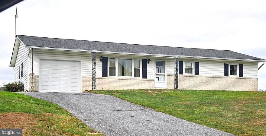 Charming 3BR 1bath ranch home nestled on .48ac corner lot overlooking peaceful farmland.  This property offers the perfect blend of comfort and country charm.  Step inside to a cozy living room and spacious eat-in country kitchen ideal for gatherings and home-cooked meals.  One step from the dining area leads to the family room with plenty of space to relax or entertain and access the level rear yard.  All three bedrooms offer great natural light and flexibility.  The finished lower level features a carpeted rec room complete with a dry bar perfect for game nights or casual entertaining.  The utility/laundry room has loads of storage space, washer and dryer with laundry tub and access to the rear yard.  Updates over the years include new windows in 2016 and water heater June 2025.  Stay comfortable year round with central A/C, electric baseboard heat, and 3 Ceiling Fans.  Outside the property offers ample parking and storage in the oversized 1-car garage and storage shed, plus plenty of yard space to enjoy.  Don't miss your chance to own this charming home with unbeatable location and room to grow.....Schedule your showing today!