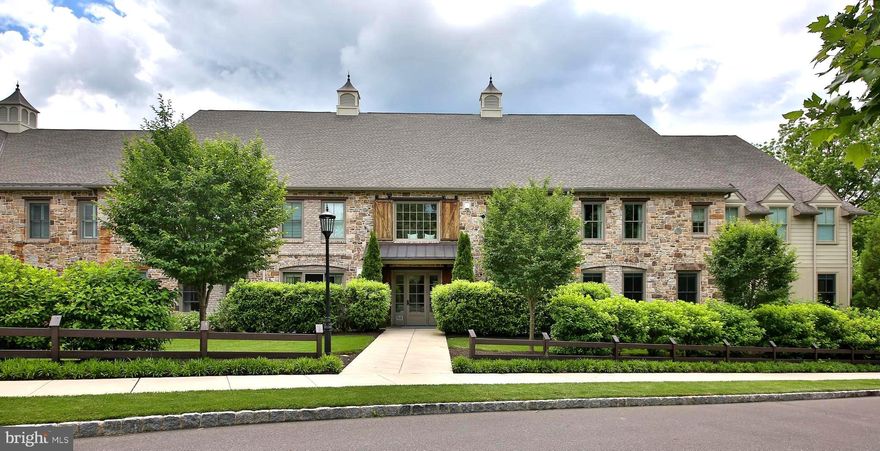 Welcome to this Zaveta Built Exclusive Towns Edge community of 10 luxury residences with amazing outdoor spaces to enjoy. This immaculate maintenance free home was the builders model and is filled with all kinds of upgrades and modern amenities that will far exceed your expectations. Upon entering this 2 bedroom, 2 full bathroom home, you will be greeted by 2,000 square feet of meticulously designed one floor living.  Hardwood floors and 9-foot ceilings create a sense of grandeur, while the designer kitchen boasts granite counters, an abundance of cabinets with glass accents, a double sink in the island with bar seating, custom pantry with roll-out shelves, and a large 5-burner Verona gas range, making for an inviting place to gather while the chef cooks. The living room has a gas fireplace faced with marble, framed with built-ins, glass shelves that illuminate, and cabinets with electric installed. Just steps from the living room is a glass door and glass surround leading to a private veranda hidden by tall shrubs for the ultimate privacy. A dining room is laid out behind the living room and kitchen in this spacious open floor plan for easy entertaining. The primary suite is a retreat with 4 windows allowing light to stream in from two sides. The walk-in closet with shelves and bars makes for the perfect changing room. Step into your spa-like primary bathroom with a stand alone soaking tub, granite double sink vanity, linen closet, and a frame-less glass shower, adding to the luxury feel of the home.  A second bedroom with ample closet space and nicely sized windows add to the warmth feeling of this room. The full bath has a granite counter top vanity with a sizable linen closet and tub/shower combo. A full laundry room has lots of counter top space for ease of use along with lots of cabinets for hiding away the items not in regular use. Throughout the home, you'll find elegant light fixtures and finishes that add to the overall sense of splendor. In addition to the stunning interior, this residence offers a double door two car garage with a large storage room (16x12 plus electric for your convenience). More amenities for the owners is the buildings elevator, a well equipped fitness area and sauna, multiple sitting areas, indoor mailboxes, and amazing outdoor options. Enjoy the 3+ acres of natural beauty when out walking along the flowering pathways around the property. A huge covered pavilion is outfitted with a fire pit, seating and gas grills for your enjoyment. The rose garden and tremendous landscaping is an extension of the luxury living you will find throughout this community. Even the inside of the pavilion looks like something out of a modern Bucks County Farmhouse. Take advantage of the opportunity to live in this unique and private condominium with all the elegant features it provides. All of this is within close proximity to Doylestown Borough with its shops, cultural district, restaurants and the Doylestown Hospital, making for a fabulous location. Come and fall in love with luxury living at The Town's Edge Private Community.