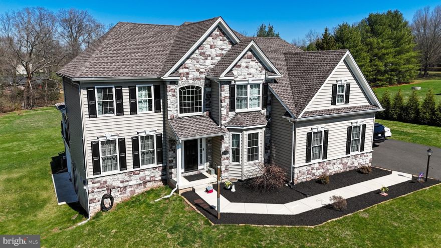 Exceptional Home in Towamencin Township – A Rare Find!

Welcome to this stunning 9-year-young home, better than new, nestled in the heart of desirable Towamencin Township! Situated on 1.25 acres of serene, level land with mature trees, this exceptional property offers a peaceful retreat in a quiet cul-de-sac neighborhood, just minutes from Merck, Sumneytown Pike, and Allentown Road.

Step outside to your backyard oasis, where a newly added covered deck and expansive seating area provide the perfect space to relax or entertain. The paver patio is thoughtfully prepped for a hot tub and features built-in seating surrounding a gas fire pit, creating a cozy atmosphere for year-round enjoyment.

Inside, the grand two-story foyer welcomes you with gleaming hardwood floors. To the left, the inviting living room sets the tone for elegance, while a private home office sits to the right. The formal dining room is designed for hosting memorable gatherings, with ample space for a large table and French doors leading to the outdoor living space—perfect for seamless indoor-outdoor entertaining!

The heart of the home is the chef’s kitchen, boasting a center island, rich cherry Century cabinets, a walk-in pantry, and ample storage with deep drawers. The bright and airy breakfast area is framed by a triple window view of the backyard, bringing in abundant natural light. Adjoining the kitchen, the spacious family room features a charming brick gas fireplace and a hidden nook—ideal for a game closet, extra seating, or a custom space of your own. A mudroom provides a convenient drop zone for coats, shoes, and backpacks.

Upstairs, the primary suite is a private retreat with two walk-in closets and a spa-like ensuite bath featuring a jetted soaking tub, dual sinks, and a stall shower. Three additional spacious bedrooms and a large laundry room with extra space for crafts, storage, or hobbies complete the second floor.

The full walk-out basement (approximately 1,300 sq. ft.) presents endless possibilities, already rough-plumbed for a future bathroom. Additional highlights include a spacious two-car garage and a third garage—a full-sized, dry storage area tucked beneath the deck, perfect for a workshop, lawn equipment, or hobby space.

With two separate access points leading to the deck and patio, this home is designed for enjoying the breathtaking property and tranquil surroundings. Don’t miss out on this exceptional home—schedule your private showing today!