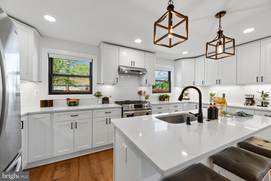 JUST REDUCED!  RENOVATED EASTPORT GEM With MODERN COASTAL FINISHES!  ABOUT THE HOME:  3 levels of luxury living featuring 4 Bedrooms and 3.5 Bathrooms. Open-concept main level with New Hickory hardwood floors and designer lighting throughout.  THE GOURMET KITCHEN:  Custom white Shaker cabinetry, modern black hardware, Quartz countertops, oversized center island, and premium stainless appliances with gas cooking. THE PRIMARY SUITE:  A rare main-level primary retreat with walk-in closet and spa-like bath featuring custom tile work and glass-enclosed shower.  THE FLEXIBLE LOWER LEVEL:  Fully finished walk-up basement with a 4th bedroom/office, family room with wood accent wall, and a custom full bath—perfect for a guest or in-law suite.  THE EXTERIOR:  Iconic white picket fence in front, with cozy front porch, and a private rear yard with beautiful wood privacy fence is expanded by an additional 736 SF (included in sale). New Andersen 100 series windows, Hardie Plank siding, and new hardscaped paths.  PARKING:  Private driveway with 2 off-street parking spaces.  LOCATION:  Unbeatable walkability to Downtown Annapolis, Maritime activities, and local favorites.  See Annapolis City site for details on the Eastport Choice Neighborhood Initiative!  Enjoy all that Eastport has to Offer! Don't Let This One Get Away! Make your Appointment Today! 
Active Ring Camera on Property.