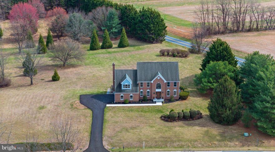 SUNDAY'S OPEN HOUSE CANCELLED DUE TO STATUS CHANGE. This spacious home sits grandly on a sprawling 4.13 acre lot, offering unbelievable views from every window! Upon entering, you are greeted to a 2-story foyer adorned with hardwood floors and a staircase highlighted with stunning wrought iron balusters. The expansive living & dining rooms have been freshly painted and are immersed with natural sunlight. Glass French doors lead to the first-floor library which provides convenience for those who work from home. The kitchen offers an island with cooktop, double ovens, refrigerator, dishwasher and large breakfast area. Step down into the dramatic family room, where a cathedral ceiling and wood-burning fireplace  create an inviting atmosphere. There is a laundry room off the kitchen with access to the garage. The powder room has been updated with new vanity & mirror. Upstairs you are greeted by the sprawling primary suite, a place of comfort and style that welcomes you with a spacious sitting area upon entering and expansive bedroom area that will accommodate all your furniture with ease! Dual deep closets provide generous storage, while the luxurious remodeled primary bath exudes sophistication with the stunning double sink vanity, elegant shower with frameless glass door and tile surround, corner soaking tub, water closet and impeccable finishes. Three additional generously sized bedrooms and an updated full bath complete the upper level. The oversized unfinished walkout basement, which is partially studded, & the finished full bath presents endless possibilities, for expansion, recreation or storage needs. Outside a large deck awaits, offering an ideal space to unwind, entertain, and enjoy the beauty of the expansive yard. With abundant space for gardening, outdoor activities, and summer barbecues, this amazing lot enhances the essence of tranquil living. Parking is easy with a 2-car side-entry garage and driveway with oversized parking pad.  The location is incredible – so close to commuter routes, parks, shopping & restaurants. With a few updates, this property has amazing potential to be the home you’ve always dreamed of!