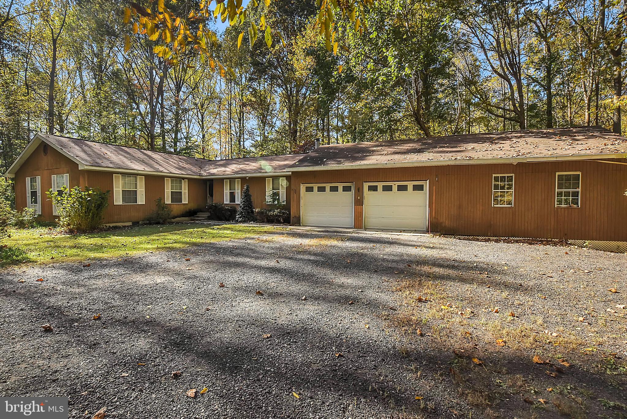 Privacy Awaits on 21+ Wooded Acres! Build your Family Compound in Northern Calvert with NO HOA. Peaceful nature surrounds you but you're only moments away from everything. Property has Mini-Subdivision potential & Seller has started the feasibility process. Per county regulations the property is legally entitled to 21 buildable lots. A deeded and private gravel driveway leads you to the current house on the land, a Country Rambler with attached oversized 2 car garage and huge workshop. The Workshop has a separate electric subpanel. With plenty of natural light on all three sides this area is perfect for a woodworker, machinist, or even artist studio.
If you enter the house from the garage, you'll arrive at a vaulted Family Room clad with historic reclaimed Calvert County Tobacco barn wood from Dunkirk where Safeway now stands. The wood fireplace in the corner is capable of heating this entire side of the house in winter. There is a potential small 4th Bedroom or Office to the side of the Family Room currently used for storage. Ahead you'll pass through the Breakfast area with sliding door and patio to the backyard. The large Kitchen could use cosmetics but creates a great open space perfect for keeping an eye on guests or the TV, hosting Football parties, Holidays, & more! The Kitchen leads to both the official Foyer in the center of the house, and the Formal Dining and Living Rooms. This area is currently used as a 5th Bedroom, and has a second sliding door leading to another patio at the backyard. Your central Foyer hallway contains the washer and dryer alcove, and if you follow another hallway to the left you'll arrive at the first Full Bath and 3 additional Bedrooms. The spacious Primary Bedroom contains a second 3/4 bath with a stand up shower and a double closet. All three bedrooms on this side of the house are ready for new carpet and paint, and already are wired for ceiling fans.
Behind the house is a wide low-maintenance yard with room for more structures to entertain like a fire pit or grilling station. This property gives you an incredible opportunity to host wildlife while still only being minutes from Shopping, Restaurants, Medical, Gyms, Fire Station, Commuter Park & Ride, and Dunkirk Regional Park & Dog Park! You're less than 3 miles from hiking or hunting along the Patuxent River at Ferry Landing (Hall Creek). Ask if your Homeowner's Insurance offers you a discount on proximity to Dunkirk Volunteer Fire House! Dunkirk is within just 30 minutes of Joint Base Andrews/ JBA and within 45 minutes of Annapolis and Washington, DC. Find out about our Rivers and Beaches, and award-winning Calvert County Schools!
With some cosmetic work you can make this tranquil 4+ Bedroom Rambler your castle. Most major appliances, utilities, septic and roof have been replaced within the last 10 years. You have plenty of room to store trucks, RV's or trailers, with lots of parking potential. Looking for a larger house but don't want to lose this great property? Ask about the house on adjoining potential additional lot at 3375 Jones Road Coming Soon.
Cost of further feasibility study is the responsibility of the Buyer. No sign on property; NO drive-by's per owner.