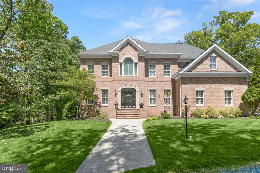 Welcome to 3619 Sycamore Valley Run, an exquisite all-brick Colonial gracefully set on 3.85 private acres in one of Western Howard County’s most sought-after communities, Cattail Creek. Showcasing exceptional renovations throughout, this remarkable residence blends timeless elegance with luxurious modern updates. Oversized windows fill the home with natural light, while classic moldings, custom shutters, tray ceilings, rich hardwood floors spanning the main and upper levels, and impressive 10+ foot ceilings on both the main and upper levels create a sophisticated and airy atmosphere. A dramatic two-story foyer is flanked by formal living and dining rooms, setting the stage for refined entertaining. At the heart of the home, the gourmet eat-in kitchen is beautifully appointed with quartz countertops, a center island with a 5 burner cooktop and breakfast bar, pendant lighting, double wall ovens, microwave drawer, decorative backsplash, apron-front sink, walk-in pantry, and an impressive beverage center featuring display cabinetry and a beverage refrigerator. The adjoining breakfast room opens seamlessly to the expansive deck and outdoor living spaces.
Just off the kitchen, the inviting family room is anchored by a pellet stove and a stunning wall of windows overlooking the meticulously landscaped grounds. A well-appointed butler’s pantry with an additional sink and beverage fridge enhances entertaining convenience, while a powder room, laundry room with built-ins, and garage access complete the main level. Upstairs, the luxurious primary suite offers a peaceful retreat with a sitting room, second fireplace, spa-inspired en-suite bath featuring dual vanities, soaking tub, glass-enclosed shower, and a walk-in closet. Bedrooms two and three share a dual-entry bath with separate vanities, and bedroom three includes an adjoining bonus room. A fourth bedroom and additional full bath complete the upper level.
The walkout lower level expands the home’s impressive living space with a game room highlighted by a third fireplace, wet bar with slate flooring, granite countertops, and wine refrigerator, along with a fifth bedroom, full bath, abundant storage, and direct access to the covered patio. Additional features include a WiFi-enabled thermostat, electric fence, remote access garage door opener, circular driveway, attached two-car garage, extended driveway, firepit, expansive deck, and beautifully landscaped outdoor spaces designed for both relaxation and entertaining.
Adding to the home’s appeal, there is no formal HOA. While optional, membership to nearby Cattail Creek Country Club offers access to award-winning golf, tennis, pickleball, swimming, a fitness center, dining, and a vibrant social calendar perfectly complementing the elevated lifestyle this extraordinary property provides. An exceptional opportunity combining luxury, privacy, and community in a premier Howard County location.