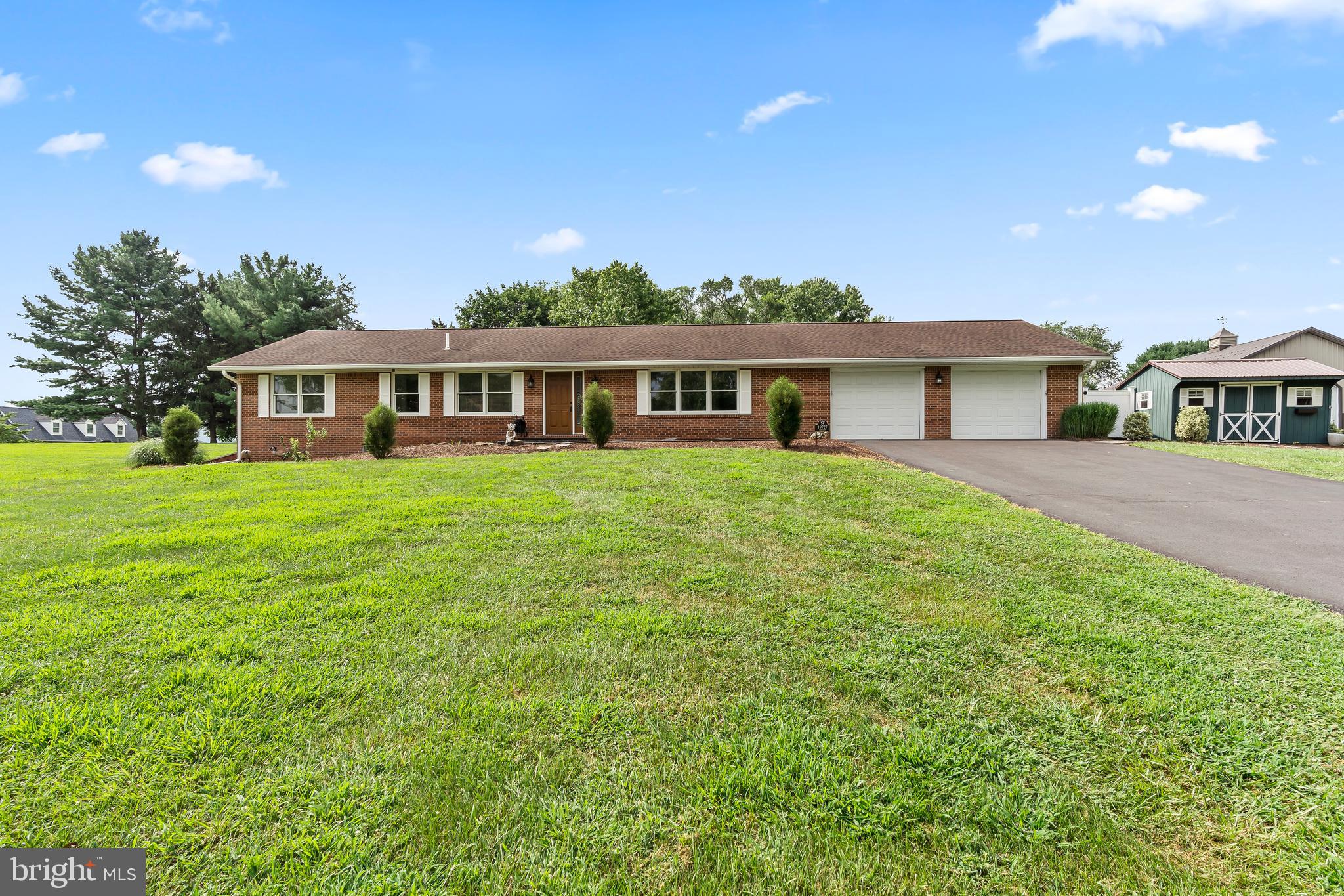 WELCOME HOME TO 19727 TOMS ROAD.
This lovely and spacious ALL BRICK 3 + bedroom home sits on 2 scenic acres of land on a road less traveled near Boonsboro. The beautiful vistas and private setting will foster the peaceable feeling that is home! Upon entering the front foyer, one will find the large, light filled living room on the right. Note the ease of flow from living room around to the kitchen, dining area and back to the foyer. The large kitchen has ample counter space, a peninsula and tons of beautiful custom cabinetry for all your food prep needs. The dining room is more than ample and provides access to the beautiful covered porch/deck out back. More on the fabulous outdoor space below! Back inside, a small hall leads to 2 nice sized secondary rooms and a hall bath. The large primary also has an attached en suite bathroom. A half bath / laundry room combo can also be found on the other side of the home on the main level. Mosey downstairs to find the huge family room, two versatile "bonus rooms" that could be used as offices or for guests, and a massive storage area with walk/up bilco to the side yard..
Back upstairs on the other side of the home can be found the oversized attached garage- over 700 sq. feet of space! The sellers finished this space as a beloved pet abode (given their love but allergies) complete with HVAC. It has been converted back to it's original purpose with the garage door opener.
Car enthusiasts and tinkers will delight in the 30x40 ft pole building which provides a spacious shop for all their projects. Electric in pole building.
The fenced backyard portion of the property is truly a gem! The security fencing creates a peaceful and private get away with numerous entertaining areas. The 32X11 covered porch/deck, complete with electric hookup for TV, is a great place to start. Enjoy a private moment in the new wood gazebo, or if feeling social, entertain guests on the massive paver patio.
Newer replacements in the last 5-7 years include HWH, well pump, front and sliding door, windows, main level carpet, roof and HVAC. This home has been lovingly cared for and dutifully maintained.
A wonderful buyer opportunity in Boonsboro schools!