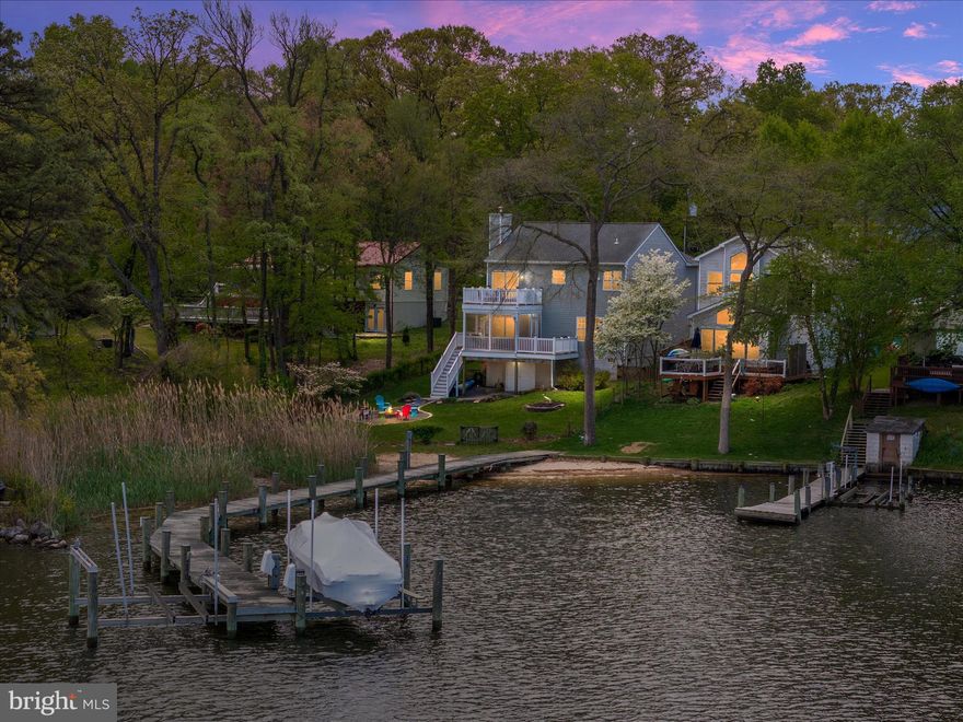 What if every day felt like a waterfront retreat?
Nestled along the shores of Furnace Creek, this exceptional residence offers a refined take on coastal living, where thoughtful design meets effortless comfort. Spanning two beautifully appointed levels, the home seamlessly blends indoor and outdoor spaces, creating an inviting atmosphere ideal for both everyday living and elegant entertaining.
The upper-level features three well-proportioned bedrooms and two tastefully designed full baths. The primary suite is a true sanctuary, with sweeping water views (the entire back of the home) and a spa-inspired en-suite bath complete with a freestanding soaking tub, an oversized frameless glass shower, and sophisticated granite finishes. The open-concept main living area is bathed in natural light, highlighting the expansive water vistas and showcasing a chef’s kitchen with a generous island and abundant cabinetry.
Outdoor living is equally compelling, with multiple decks offering serene vantage points, as well as a screened-in patio below—perfect for relaxed evenings or hosting guests. The lower level adds warmth and character with a stacked-stone fireplace and convenient full bath, creating an intimate setting after a day on the water.
Step outside to a lush, manicured yard with a firepit, leading directly to your pier equipped with electricity, running water, and a boat lift. Whether it’s boating, fishing, crabbing, watersports, or simply unwinding by the water, this property delivers a lifestyle defined by ease and recreation. Generous under-home storage ensures ample space for all your waterfront essentials.
A rare opportunity to experience elevated waterfront living in Anne Arundel County—this is a home where every detail is designed to inspire.
Please note: pier is shared with next door neighbor. Owners pay electric for dock and neighbors pay water. 
Open House: Sunday, 04/26 from 11a – 1p.