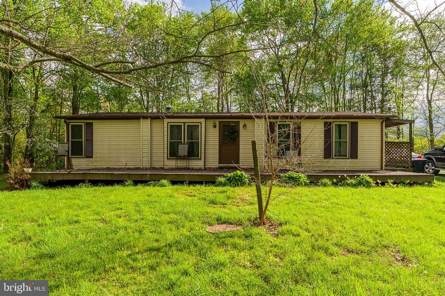SHORT NOTICE AUCTION June 3rd at 5:30 p.m. Single family detached modular home on 3.87 acres.  The main floor has 1,300+ sq ft w/ primary Bedroom / en-suite bath, 2 guest Bedrooms, 1 guest bath, kitchen, open format dining / living room w/ wood burning fireplace and a laundry room.  The basement has 1,291 sq ft and is partially refinished w/ kitchen / dining area, living / family room, 2BRs, bathroom and laundry room.  There is also a storage / utility room with exterior stair access.  200 Amp electric, on-site water and on-site septic w/ sand mound, propane forced hot air, central air on main floor.  Basement has electric baseboard heat. House needs interior and exterior renovations.