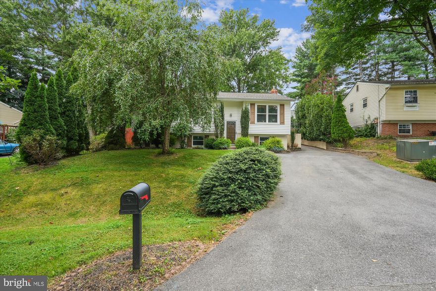 Welcome to this beautifully expanded and updated home in The Plantations!  This spacious 4-bedroom, 3-bathroom residence sits on just over a quarter-acre lot and offers a blend of comfort, style, and functionality.  Step inside to find gleaming hardwood floors throughout the main level, leading to an expansive family/great room featuring skylights, custom built-ins, and a cozy wood-burning fireplace . The generously expanded primary suite is truly a retreat, featuring an en-suite bath with walk in shower, double vanity and ample space for relaxation, reading, and recharging.  The kitchen is on full display with Zodiac counter tops, induction stove, stainless appliances and beautiful cabinetry. The finished lower level features a fourth bedroom, full bathroom and a large recreation space which can accommodate guests, a home office, or multi generational living.  The backyard is a show stopper and provides multiple outdoor experiences with a firepit, patios, a playset, and plenty of room to entertain or unwind.  This home is a rare find—offering space, upgrades, and standout features both inside and out. Additional updates include (roof 2020, dishwasher 2025, microwave 2024,  HVAC 2018, washer/dryer 2018) Welcome Home!