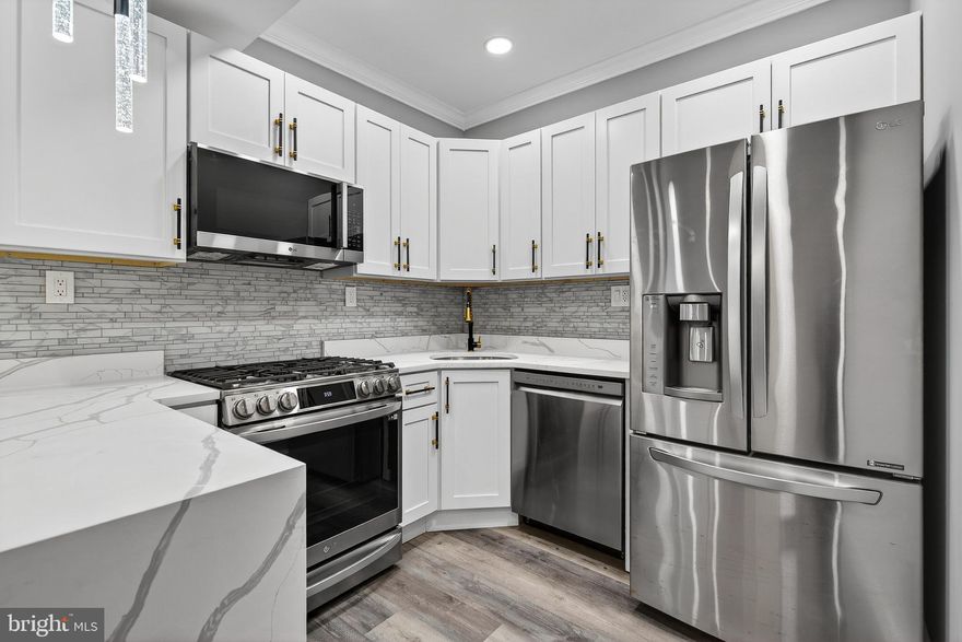 Welcome to this fully updated three level home offering 4 bedrooms and 3.5 bathrooms, located in the Winchester neighborhood. The main level features a convenient half bath and a beautifully updated kitchen showcasing a modern peninsula, quartz countertops, stainless steel appliances, stylish backsplash, recessed lighting, and contemporary fixtures throughout. The upper level offers three spacious bedrooms, including a primary suite with a private full bathroom. A washer and dryer are also conveniently included on this level for added comfort and functionality. The fully finished lower level adds exceptional versatility with a generously sized bedroom, a full bathroom, laundry hook-ups (yes! two laundry hook-ups!) with one set of washer and dryer included on the sale, and a wet bar, perfect for entertaining or additional living space. Step outside to a fully fenced backyard, ideal for relaxing, entertaining, or outdoor activities. The property also features two rear gravel parking spaces. Conveniently located near shopping, dining, and the many amenities of Gwynns Falls / Leakin Park, with easy access to Downtown. Schedule your private showing today!