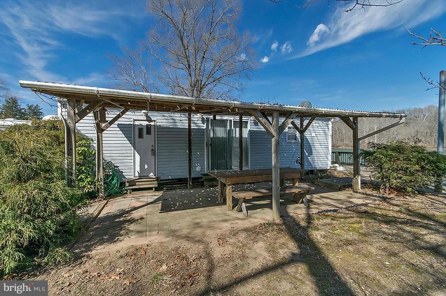 Potomac River Front Property - 40' River Frontage with Park Model Camper has Covered Porch, Poured Concrete Patio over looking river. River Bend Membership Corp (fka Jellystone Park). Stunning Views, deep water, shed, off-street parking. Community offers 3 pools, playground, Putt-putt golf, bath houses, laundry, picnic, boat ramp, club house, convenience store - gated community. Furnished.