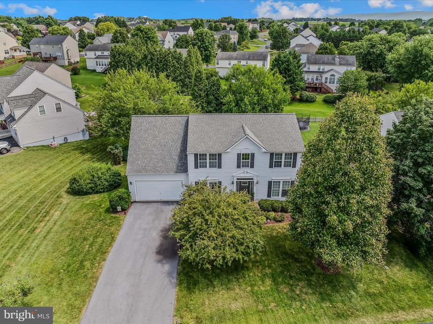 Welcome to this beautifully maintained 4-bedroom colonial home located in one of Charles Town's most sought-after communities. This property perfectly blends recreational amenities with commuter convenience, situated just minutes from Sam Michaels Park, historic downtown Charles Town, and Harpers Ferry, providing both comfort and accessibility.Upon entering, you’ll be welcomed by an inviting open-concept layout on the main level. This space features warm hardwood style laminate flooring and ceramic tile throughout, including a formal dining room and a spacious kitchen equipped with a center island and a breakfast dinette—ideal for everyday meals as well as entertaining guests. Upstairs, you will find four generously sized bedrooms and two full bathrooms, offering ample space for relaxation and play. The primary bedroom suite serves as a tranquil retreat, featuring a large walk-in closet, a soaking tub, and a separate shower. There are also two half baths conveniently located—one on the main level and another in the fully finished recreation room, making this home well-suited for modern living. Step outside onto the expansive upgraded deck that overlooks a beautifully landscaped yard, which features a custom firepit—perfect for outdoor entertaining or relaxing evenings. The backyard backs onto the community common area, providing enhanced privacy and a peaceful green space. Residents will enjoy access to multiple playgrounds, basketball courts, and a community baseball field, all within the neighborhood. With its proximity to major commuter routes, this location is ideal for those traveling to Maryland, Northern Virginia, or the Washington, D.C. metro area. Recent updates include: Roof-4 yrs old, Heat Pump-2 yrs old.