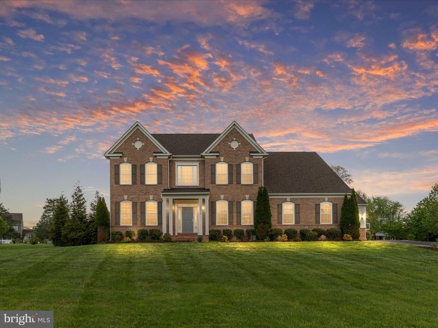 Welcome to this exceptional brick-front colonial estate, perfectly situated on nearly six acres of professionally landscaped grounds featuring extensive hardscaping and a serene private pond with a water feature. This turn-key luxury residence offers timeless elegance, a spacious three-car garage, and over 6,000 square feet of beautifully finished living space. As you step through the grand two-story foyer, you're greeted by wide-plank, hand-scraped hardwood floors that flow throughout both the main and upper levels. The main floor boasts 9-foot ceilings, sophisticated modern lighting, a formal living room, an elegant dining room with wainscoting and crown molding, a spacious office with French doors, a stylish powder room, and a welcoming family room highlighted by a double-sided gas fireplace. The adjacent gourmet kitchen is a showstopper, featuring sleek quartz countertops, soft-close cabinetry, a custom tile backsplash, premium stainless steel appliances, a large center island with pendant lighting, a walk-in pantry, and designer tile flooring. Upstairs, you’ll find four generously sized bedrooms, three full baths, and a well-appointed laundry room with built-in cabinetry. Two bedrooms share a Jack-and-Jill bath, while a princess suite enjoys its own private en-suite. The luxurious primary suite offers a tray ceiling, a relaxing sitting area, and a stunning spa-like bathroom with upgraded tile, dual granite vanities, a soaking tub, and a large walk-in shower with double showerheads. The custom walk-in closet is amazing and thoughtfully designed with a premium organizer system. The fully finished lower level is ideal for entertaining, featuring a massive rec room with recessed lighting, an impressive theater room with built-in surround sound, projector, tiered seating, and custom lighting, as well as a fifth bedroom, full bath, and ample storage space. Step outside to your private backyard oasis with a sprawling custom tile patio, built-in grilling station, elegant stone knee wall, charming gazebo, and expansive level yard—perfect for outdoor living and entertaining. The picturesque pond, surrounded by mature landscaping and complete with a water feature, provides a truly tranquil backdrop. This one-of-a-kind property seamlessly blends luxury, comfort, and natural beauty—an extraordinary place you’ll be proud to call home. ***HVAC 2024!***