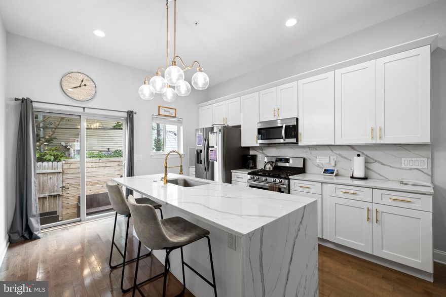 Experience modern luxury in this beautifully updated townhome. The open living area boasts high ceilings, leading seamlessly to a sun-drenched grand living room and a state-of-the-art, open-concept kitchen. This kitchen is a chef's dream, featuring updated finishes, shaker-style soft-close cabinets adorned with elegant golden knobs, and modern quartz countertops with a matching backsplash. The upgraded farmhouse sink, with a brushed gold faucet that complements the cabinet handles, adds a touch of sophistication, while the stainless steel appliance package (including a dishwasher, fridge, range, and microwave) ensures top-tier functionality. Under-cabinet lighting enhances the ambiance, and just off the kitchen, a charming back patio awaits.
Ascending from the first floor, wide, commercial-grade pine staircases, secured by custom railings, lead you to the second floor. Here, you’ll find two generously sized bedrooms, a full bathroom with a custom vanity, and a convenient laundry closet. The third floor is dedicated to a luxurious primary suite, offering a spacious bedroom, a spa-like bathroom with custom tile work, a dual vanity, a soaking tub, a designer rainfall shower, and a walk-in closet. The top floor also provides access to a private rooftop deck, complete with electric and water lines, perfect for hosting gatherings.
The finished basement adds even more versatility to this home, featuring another large bedroom or home office, a custom full bathroom, and a utility closet. With its blend of modern updates and thoughtful design, this home is truly an urban oasis.
This home is currently operating as a profitable short-term rental on Airbnb, generating consistent monthly income.