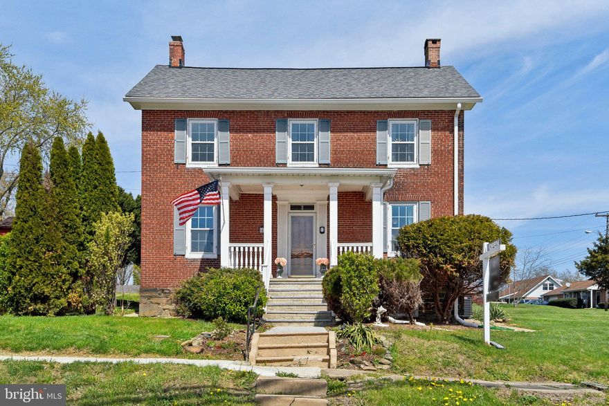 Wow! Make history and almost instant equity with a funded Maryland streetscape project. Step into timeless elegance at 414 High Street, a beautifully updated Colonial in the heart of historic New Windsor! This stately 3-bedroom, 3-bath home brimming with character and modern comforts sits on a generous half-acre corner lot.

Entering a foyer off of the long side porch, you'll find a welcoming dining room with plenty of built-ins, a wood-burning insert—perfect for gatherings—and a spacious kitchen with ample cabinetry, recessed lighting, and a handy pantry.  Check out the powder room where you'll see a modern twist on an antique that was once the heartbeat of every household!  The formal living room has more built-ins and a cozy gas fireplace. Notice the original oil lamp hardware in the family room and all of the beautifully refinished floors.

Upstairs, the primary suite is a true retreat, featuring a brand-new private balcony off of a large office with an additional walk-in closet — ideal for working from home or unwinding in style.  Vintage charm meets modern luxury in the suite’s private bath featuring a refinished clawfoot tub. More large bedrooms and a shared bath along with a dedicated laundry room complete the upper level.

The basement doubles as a workshop and features an electric fireplace, making it a versatile space for hobbies or relaxation.

A brick paver patio, privacy fencing, dedicated garden shed, and a rare detached three-car garage with full attic offer a rare combination of modern utility and historic charm. Recent upgrades include newer windows and roof, a new boiler and HVAC system, water heater, and a fully replaced public water supply line to meet county requirements—giving you peace of mind for years to come.

This address is the first address included in the state's streetscape project, which will add brand-new sidewalks and pedestrian lighting—enhancing walkability, safety, and curb appeal for the entire neighborhood. Don’t miss your chance to own this historic gem with modern upgrades and unbeatable small-town charm!