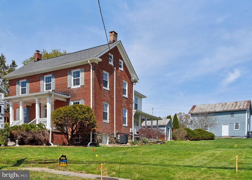Wow! A beautifully updated Colonial with rare space, character, and major system upgrades — all on a half‑acre corner lot! Recently adjusted price — seller will review all offers on May 4th.

Make history and almost instant equity in the heart of historic New Windsor: this home is the first address included in the state-funded streetscape project, which will add brand new sidewalks and pedestrian lighting, enhancing walkability, safety, and curb appeal for the entire neighborhood.

Step into timeless elegance at this stately 3-bedroom, 3-bath home brimming with character and modern comforts. Entering a bright foyer off of the welcoming side porch, you'll find a dining room with plenty of built-in cabinets, a wood-burning insert—perfect for gatherings. Check out the powder room where you'll see a modern twist on an antique that was once the heartbeat of every household!  The spacious kitchen has plenty of countertops and cabinetry. The large, formal living room has more built-in shelving and a cozy gas fireplace. Notice all of the multi-use space and beautifully refinished floors.

Upstairs, the primary suite is a true retreat, featuring a brand-new private balcony off of a large office with an additional walk-in closet ideal for working from home or unwinding in style. Vintage charm meets modern luxury in the suite’s private bath featuring a refinished clawfoot tub. More large bedrooms and a shared bath along with a dedicated laundry room complete the upper level.

The basement doubles as a workshop and features an electric fireplace, making it a versatile space for hobbies or relaxation. The walk-up attic has hickory flooring, new windows, and plenty of storage.

A brick paver patio, privacy fencing, dedicated garden shed, and a rare detached three-car garage offer a rare combination of modern utility and historic charm. Use your imagination in the garage attic, which adds an additional 600 square feet of space. A long list of recent improvements is attached, including HVAC, water heater, and a fully replaced public water supply line to meet new county requirements. All of this and a home warranty is included, giving you peace of mind for years to come! Don’t miss your chance to own this historic gem with modern upgrades and unbeatable small-town charm!