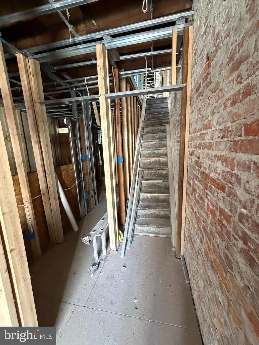 INVESTOR SPECIAL:  ROUGH-INS COMPLETE!  Skip the demo and permit delays- this legal duplex (RSA5) in 1939 is ready for its finish line.  The heavy lifting is done: new PEX manifold plumbing system, updated electrical panel, and modern metal framing are already in place.  This property is stripped to the bones and rebuilt with efficiency in mind.  Stunning exposed brick walls throughout provide the perfect "modern industrial canvas. Strategic location near Market St with a massive $300+ ARV potential.  Sold strictly AS-IS.  Buyer is responsible for all municipal certifications, final permit inspections, and U&O.  Grab this head start and start your finish today