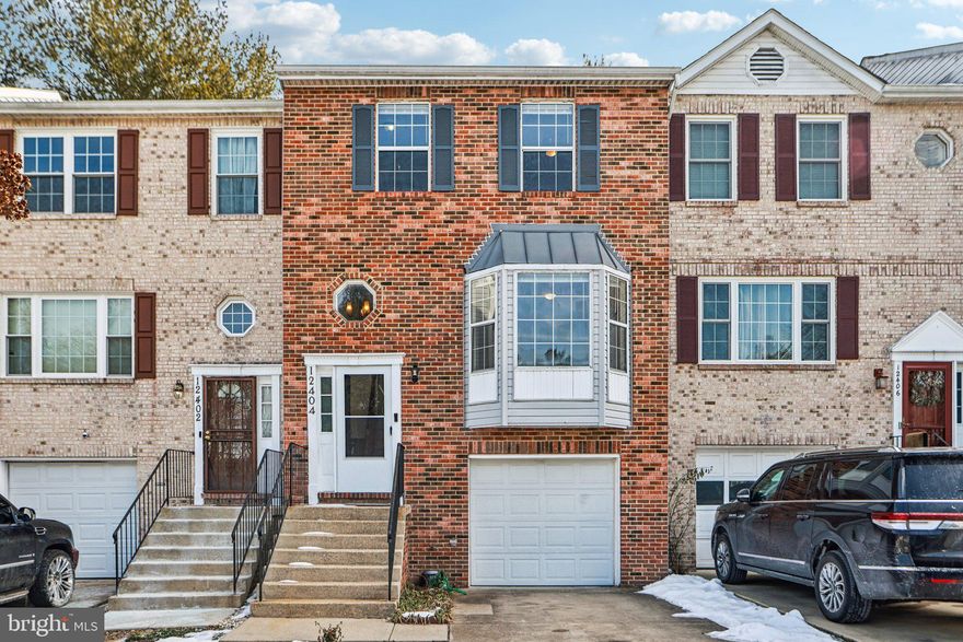 ***Back on the market, buyer lost employment*** Don’t miss your chance to own this stunning brick-front townhouse! With gorgeous wood flooring on the main level, this home features a spacious living room, a full kitchen, and a separate dining area, along with the convenience of a half bath. Upstairs, you'll find three generously sized carpeted bedrooms, including a primary suite with a full bath, plus a guest bathroom for added comfort. The fully finished, carpeted walk-out basement includes a laundry room and offers easy access to a large backyard, perfect for entertaining or relaxing. This home has it all—act fast before it's gone! The roof was replaced in 2018 and there is a Home warranty that transfers with ownership that expires 10/2026.