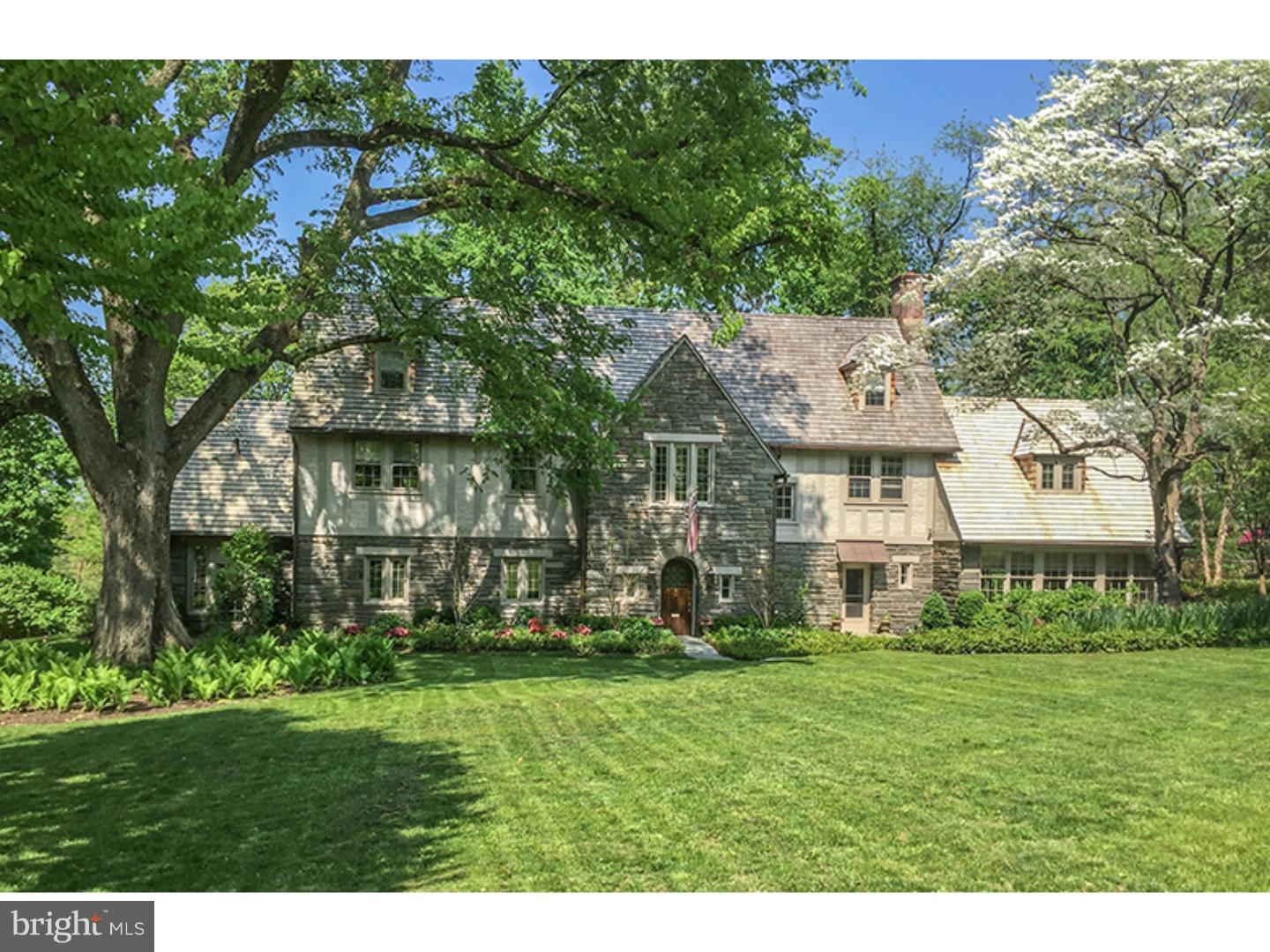 Beautifully sited on 1.3 acres of lush lawns, mature trees, and lovely gardens, this 1926 English Tudor maintains the charm and characteristics of its history whilst the chic upgrades ensure the ease of modern living. There is a gorgeous new cedar roof , new copper gutters, and the exterior is freshly painted. A new 2 car garage mimics the architecture of the house seamlessly. The 2nd floor of the garage is ready to be finished into a guest cottage, exercise room, home office or whatever best suits. A new underground sprinkler system will keep all the mature trees, lawn and gardens healthy. Enter the home through the arched leaded glass door. The floor plan enlists the best space planning principles and is perfect for entertaining. The large living room has French doors leading to the rear patio and the lovely fireplace is a strong focal point. The adjacent sun drenched conservatory has new travertine floors with radiant heating. The large dining room with bay windows also has direct access to the rear gardens. The modern kitchen has Carrara marble backsplash, black granite counter tops and a gourmet range. Custom built cabinetry conceals the appliances including 2 dishwashers and refrigeration. Ideal for casual living, the adjacent family room has exquisite, new , custom cabinetry and direct access to rear yard. A new powder room completes this level. Up the gracious staircase to the second floor also planked with oak flooring is the master bedroom suite. The new master bathroom has a custom vanity with double sinks, a frameless glass enclosed shower, radiant floor heating and a towel warmer. The custom built dressing room will please even the most discerning. This floor has 2 additional bedrooms, 2 additional full baths and an office. The third level has 2 additional bedrooms, a full bath and 2 storage closets, one cedar lined. New, security system with advanced features is state of the art. All this in the highly sought after Chestnut Hill neighborhood of Philadelphia.