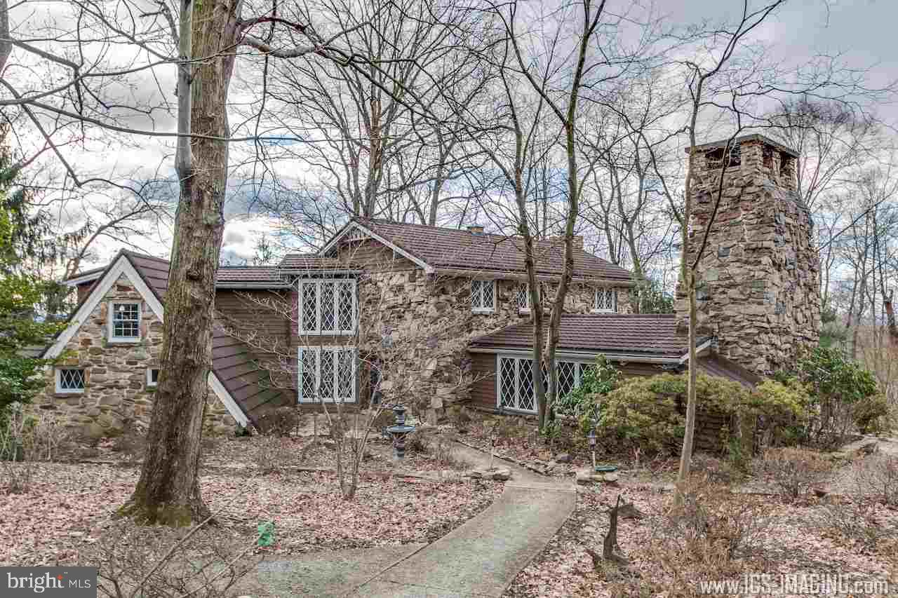 A rare find on Blue Mountain! This unique chalet-style home, with two large wooded lots, is a fabulous hideaway yet still close to town. Features include a HUGE walk-in fireplace in a brick-floored family room, beautiful vistas of the valley, a cottage for out of town guests, tennis court, a party room with kitchen, and three additional stone wall fireplaces. Large back deck, with work, holds great potential. The guest house is 864 sq ft with central air and a full bath. Possible Clean and Green zoning.