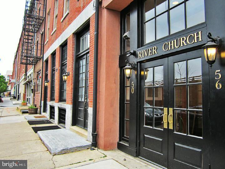Welcome to River Church! Step into this spacious 1-bedroom, 1-bath condo, boasting over 1,000 square feet of character-filled living space in the heart of Philadelphia’s coveted Old City. Located on the top floor of a beautifully converted historic 125 year old warehouse, Unit 502 perfectly blends industrial charm with modern comfort.
Soaring ceilings, oversized west-facing windows, and original exposed brick walls create an airy, dramatic space filled with natural light. It has generous open living/dining area with gorgeous pine hardwood flooring and a wood burning fireplace for cozy ambiance and extra warmth in the winter. With an upgraded kitchen with stainless steel appliances, granite counters, and custom cabinetry and in-unit washer and dryer, this condo has everything you need for your convenience. It also boasts a hard wired audio system throughout the unit to entertain your dinner guests. There are lofts in both the living room area and bedroom, which are ideal for a home office, guest sleeping area, or creative studio, plus a custom walk-in closet, custom built-in wood drawers and storage under both staircases.
It also has stunning shared roof deck with panoramic views of the river, bridges, and city skyline – perfect for entertaining or relaxing and its all within short walking distance of famous Elfreth's Alley, Penn's Landing, bus stops, Menagerie coffee and the Arden Theater and a stone's throw from 95. There are tons of fantastic restaurants, bars and Independence Mall just around the corner.
This condo doesn't just offer a beautiful home to live in, it also gives you a lifestyle of walking to your favorite places, bars, restaurants, cafes and friendly faces in one of Philly's most charming and architecturally interesting neighborhoods!
Schedule your private tour today and experience elevated loft living in Old City.