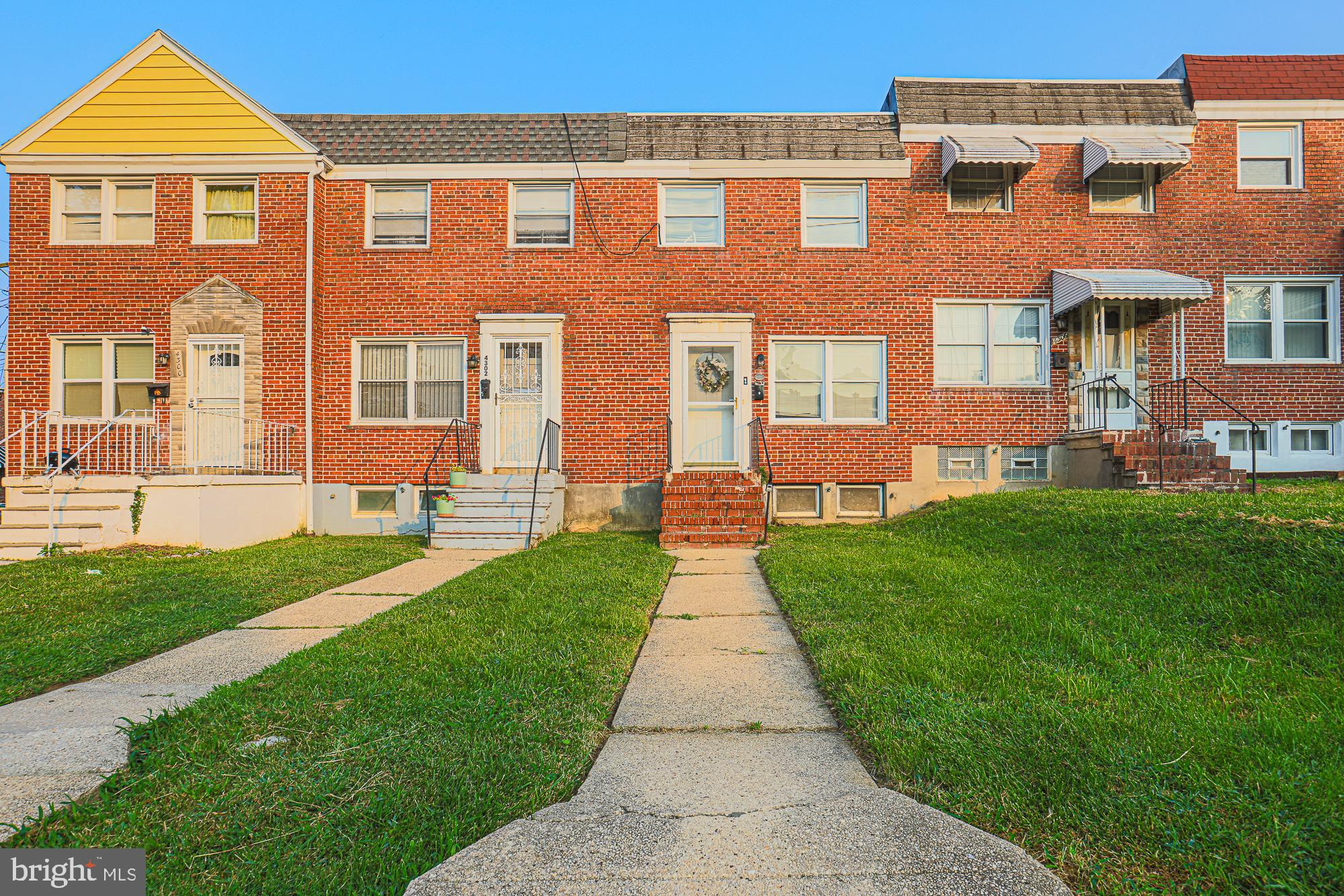 Looking for a project with strong investment potential in Baltimore’s diverse Parkside neighborhood? This 3-bedroom, 1.5-bath brick townhouse offers a canvas for your vision! Lush grass borders the path to the front entry, setting the stage for what’s inside. Your main-level living room embraces guests for a relaxed evening in with cocktails and conversation. A dining alcove, just steps from a kitchen with plentiful cabinetry, creates an intimate mood for celebrations. Upstairs, a generous primary with a walk-in closet shares a full bath with another inviting retreat. Downstairs, rich wood paneling adds character to the third bedroom, complemented by a utility area with laundry and a handy water closet. Venture out back to a fenced lawn ready for games, gardening, or gatherings under the covered porch. Positioned near Lower Herring Run Park, local shops, eateries, major highways, and Morgan State University, this home connects you to Baltimore’s city life with ease. Come see where imagination and effort could shape a truly rewarding outcome! New roof installed in March of 2025.