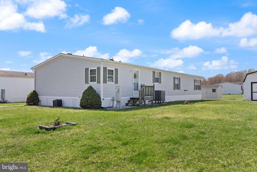 Welcome to this beautifully upgraded and spacious double wide mobile home offering 1,848 square feet of comfort and charm. This 3-bedroom, 2-bath home is warm, inviting, and move-in ready, featuring newer carpet, crown molding, chair rail throughout, and all new lighting and fixtures. The stunning kitchen includes 42” upgraded white cabinets, stainless steel appliances, beveled edge countertops with seating, and plenty of cabinet  and counter space. Enjoy a cozy electric fireplace in the living area, five ceiling fans for year-round comfort, a large laundry/mudroom, and an upgraded master bath along with an updated second full bath. Unique to this home are its three separate exit doors—front, side, and rear—all with screen doors. Concrete sidewalk access, offering convenience and flexibility. Additional highlights include a new Lennox HVAC system (inside and out)and a shed with a new roof, exterior upgrades, and built-in shelving. A 2-car parking pad adds off-street convenience, completing this well-maintained and thoughtfully enhanced property. Don’t miss your chance to own a home that truly stands out from the rest—schedule your tour today!