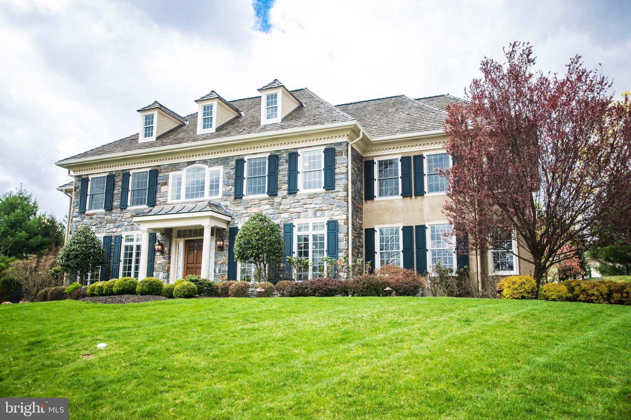 You can have it all! Enjoy the privilege of living in an enclave of 22 custom Estate homes strategically located in the heart of the Main Line. Boasting ease of access to all of life's destinations including major roadways, the train, corporate centers,hospitals , schools, universities, shopping, sports facilities, houses of worship and entertainment. Ann Capron designed this Elm Model that was built in 2006 by the prestigious Bentley Builders. Perched on a premium Cul de Sac lot that has been improved with a stone lined drive, stone patio and hardscaping with landscaping, a lush lawn and mature trees. This lot offers the opportunity for total privacy while in a community; it has also been approved for a pool and backyard oasis. This English Manor home welcomes you with a stone front, portico, sweeping two story foyer, grand staircase, wainscoting and beautiful detail. On the Main Floor well a appointed Living Room, Dining Room with Butlers Pantry, Library featuring Cherry Built Ins and a window lined Music Room create the formal areas of the house. An Open Gourmet Kitchen with GE Monogram appliances, Island seating, sun filled Great Room, Breakfast Room, two Powder Rooms and second set of steps create a warm environment. On the Lower Level of the home you and your guests can experience the Professional climate controlled walk in Wine Cellar, Game Room and expansive natural light filled playroom with bathroom. On the Upper floor of the home a full Master Suite with large Walk in Closet equipped with built ins, Master Bath with wonderful shower and Jacuzzi tub. There are three additional sizable bedrooms with a hall bath and a princess suite with private bath. The Laundry is centrally located on the Upper Level. This property is spotless, has just been freshly painted with neutral colors throughout. It is in move in condition and is a must see!