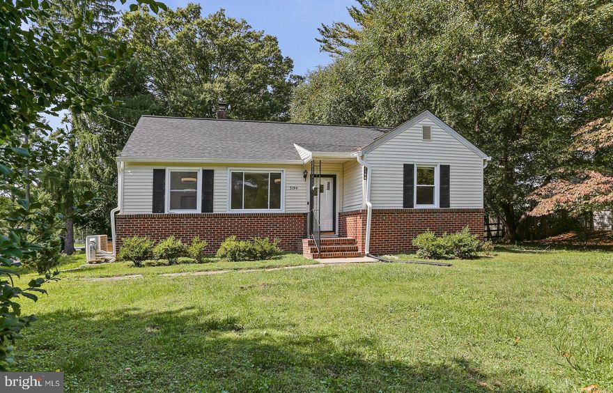 Beautiful and practical! Welcome to this adorable brick home on a gorgeous corner lot, with a HUGE level yard! Dotted with mature landscaping and fenced, it is a wonderful space for entertaining! You will enter through the side door, into a big bright foyer. To the left is a lovely primary suite boasting a fabulous bathroom with shower, separate soaking tub, and double vanities. This suite is a lovely, private, and accessible retreat! From the foyer, the main living space is to the right. The kitchen has been updated with stainless steel appliances and a granite countertop. There is hardwood underneath the carpet in the big bright living room. Three additional bedrooms grace that level, also with hardwood. The lower level is fully finished and has a full bath, kitchenette, spacious laundry, and separate bedroom, all with new LVP flooring.  Enjoy this idyllic retreat, close to Route 40 and wonderful restaurants and shopping! New roof and gutters 2024. Shed as-is