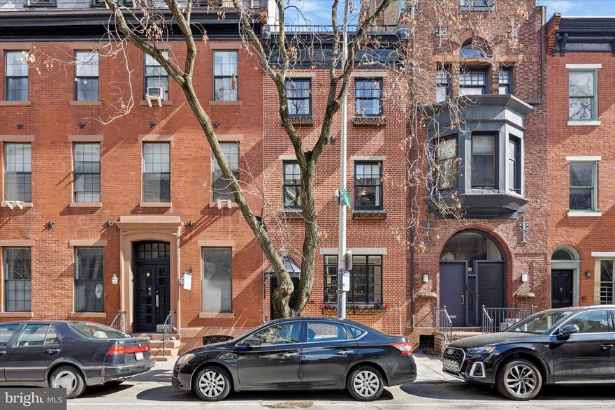 Welcome to this beautifully updated three bedroom two and half bathroom townhome located in the heart of Rittenhouse Square!

The newly re-pointed, classic red brick facade is accentuated by the original  Art-Nouveau styled glass crystal awning giving this home serious curb appeal! Step into the large, glass-enclosed entry foyer, which boasts custom-built storage and a generous built-in coat closet with storage bins, making organization a breeze. This home offers a perfect blend of modern luxury and classic charm.  The kitchen is a chef's dream with high-end appliances including a 36-inch dual-fuel matte white professional range from Cafe with an integrated Brizo pot-filler.  Plentiful cabinetry is blended perfectly with the Caesarstone countertops and a large farmhouse sink with Brizo faucets, and glass pendant Hudson Valley Lighting over the peninsula. The kitchen opens to a large, light-filled dining and living area, complete with a gas fireplace, built-in storage, and expansive space for entertaining.  The home features original pine floors throughout several rooms.


The second floor is dedicated to comfort and convenience with a private office suite through a set of French doors, and a spacious primary bedroom retreat. The large, sunlit bedroom has the home's second fireplace as the focal point, perfect for those cozy winter evenings!  The newly renovated walk-in closet is designed for ultimate organization and features built-in cabinets, drawers and laundry hampers.  The spa-like primary bath was gut-renovated in 2024 and offers dual vanities, a massive steam shower, a freestanding tub, and radiant heated floors and Carrera marble for the ultimate relaxation experience.

On the third floor, you’ll find two additional bedrooms, a full bathroom, and a spacious den — perfect for a media room, playroom, or cozy retreat. The pièce de résistance is the expansive roof deck, which spans the entire footprint of the building and offers breathtaking views of the city, providing a perfect space for outdoor living and entertaining.  There is a spacious headhouse on the roof deck for additional storage needs as well.  The finished basement offers even more flexible living space. 

Located just two blocks from Rittenhouse Park, this home is ideally situated for enjoying all that this vibrant neighborhood has to offer. As an added bonus, the sellers are offering one year of pre-paid parking nearby with an acceptable offer. Don’t miss the opportunity to own this exquisite home in one of Philadelphia’s most sought-after locations!