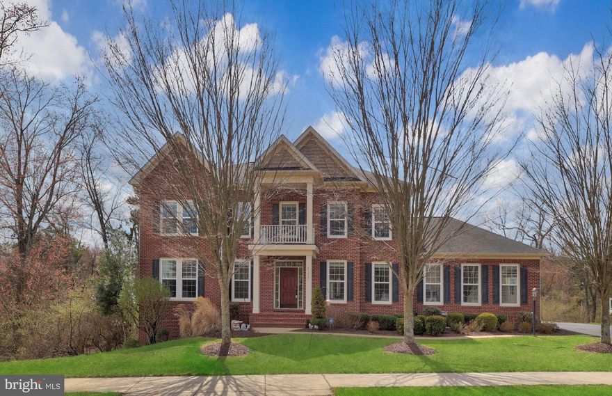 Welcome to 41525 Goshen Ridge Place, an exquisite 5-bedroom, 5.5-bathroom single-family home located in the prestigious Marrwood at Stone Ridge community in Aldie, Virginia. This meticulously upgraded residence offers over 6,300 square feet of luxurious living space, providing an exceptional blend of comfort and sophistication. Upon entering the grand foyer, you'll be captivated by the elegant hardwood floors, custom moldings, and tasteful color palette that flow throughout the home. The gourmet kitchen is a chef's delight, featuring stainless steel appliances—including double ovens, a built-in microwave, gas cooktop, center island, butler's pantry, and recessed lighting. The kitchen seamlessly connects to a bright breakfast nook, perfect for casual dining. Adjacent to the kitchen, the inviting family room showcases a wall of windows, bathing the space in natural light. The main level also boasts a formal living room, dining room, private office, and a mudroom off the kitchen/garage equipped with an additional sink and refrigerator, enhancing everyday convenience. Upstairs, each of the four bedrooms features hardwood floors and its own en-suite bathroom, providing privacy and comfort for all family members and guests. The luxurious primary bedroom suite is a true retreat, offering a spacious sitting area, coffered ceilings, and an abundance of natural light from multiple windows. The spa-like primary bath features a separate tub and shower, dual vanities, and a large walk-in closet, providing both elegance and functionality. The fully finished, walkout basement is an entertainer's paradise, featuring a media room, fifth bedroom, full bath, wet bar with a mini fridge and dishwasher, and a versatile bonus room—ideal for hosting gatherings or enjoying leisure time. Hardwood floors were added to both the basement and main-level family room in 2021, enhancing the home's aesthetic appeal. Situated on a 0.29-acre lot, this home offers a serene setting with a backyard that backs to trees, providing privacy and a tranquil view. Additionally, the front of the house also offers a view of trees, ensuring privacy when inside the home. Recent updates include an irrigation system installed in 2021 and an updated upstairs HVAC system in 2020, enhancing the home's efficiency and comfort. Conveniently located near top-rated schools, shopping, dining, and major commuter routes, this property combines luxury living with everyday practicality. Don't miss the opportunity to own this exceptional home. Schedule a private tour today!