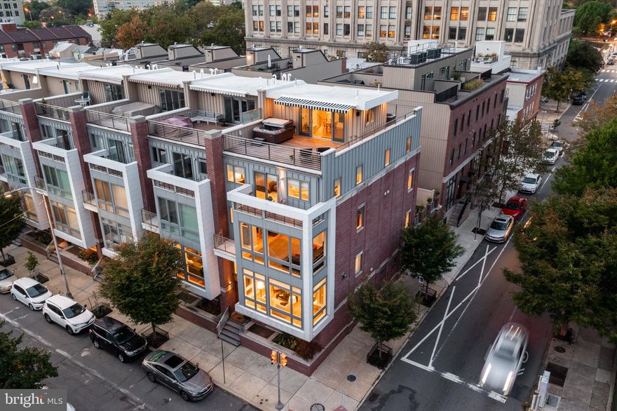 Welcome to this Logan Square townhome designed by JK Roller Architects and built by the builder to be his personal residence.  Completed in 2018, this 25ft wide custom home is two feet wider than other homes on the block and includes numerous upgrades above the standard luxury features.  This sun drenched corner residence features 1,350 sq ft of outdoor spaces over 5 areas, two-car garage parking, a completely finished lower level,  10’ ceilings, automated blinds, sound system throughout with individual controls on each level, intercom system, sprinkler system,  security system, central vacuuming and beautiful reclaimed wood floors. The mahogany paneled elevator stops on all six levels from the basement to the pilot house.  Enter the home through the solid mahogany front door and step into a tiled foyer with soaring ceilings.  Just a few steps down and you reach a corner bedroom with en-suite bathroom,  perfect for an in-law suite or private guest bedroom. On this level, you also have access to the oversized two-car garage with abundant storage.  Follow the custom stainless steel staircase with reclaimed wood treads and tremendous wall space for your art collection to the expansive living room, kitchen, and dining area, which is drenched in natural light from oversized windows and features a beautiful gas fireplace.  The eat-in kitchen features an oversized Quartz Island and countertops, custom cabinetry, Subzero refrigerator, Wolf dual-fuel range stove with hood, Wolf E series convection wall oven, two sinks, two Miele dishwashers, a Grohe water filter and water carbonation system, built in espresso maker and microwave; a perfect kitchen for gathering with family and friends. There is also a 72 bottle temperature-controlled wine closet and a discreetly located powder room with beautiful marble floors.  The sliding glass doors lead to a large patio with direct gas grill and custom pergola adding space to entertain and relax.   Two bedrooms and a den are located on the third floor, both offering en-suite bathrooms with heated flooring. Also on this floor is a den and separate utility/laundry room.  The next level is the spacious primary bedroom suite with inlay hardwood floors, extra-large walk walk-in closet and a private terrace. The elegant five-fixture primary bathroom features a separate water closet,  beautiful white porcelain tile walls and flooring perfectly accented by a quartz vanity top and  complemented by white cabinetry.  A three head rain shower with steam, a bubble-soak tub, and heated floors help to infuse every day with luxury. The top floor offers a spacious enclosed pilothouse with a powder room and kitchenette complete with a wine fridge, mini fridge, a full size dishwasher and microwave.  Both the north and south roof decks offer dramatic skyline views. The southern facing deck features a Sunesta retractable awning, a hot tub and privacy screen. On the lower level of this home you will find a complete home gym and a separate entertainment room. You will never want to leave this remarkable home.  This residence includes two HVAC systems and a separate HVAC system for the pilothouse allowing for total comfort control.  Two energy efficient Navien condensing tankless water heaters ensure you will never be without hot water.  Five full years remain on the 10 year tax abatement!  Located within the Greenfield Catchment and in close proximity to the Museum District, 30th St. train Station, and easy access to I-76 and I-95 this home allows exceptional ease entering and leaving the city.  Homes like this don't come on the market very often so make an appointment to check it out today!