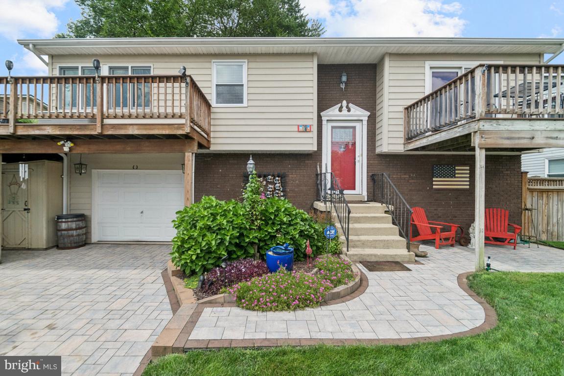 You will love this amazingly maintained Waterview home. Upper and Lower custom four season porches shades, ceiling fans. & recessed lighting. Gally kitchen with large breakfast bar/ center island and walk in pantry. beautiful water views from most rooms on the main level. Spacious Lower-level Family rm. includes propane fireplace, TV mounting, additional storage, full bath and additional living area. Multiple water view decks w/convenient water hose access. Stunning rear yard includes goldfish pond, patio, lower porch access. meticulous landscaping both front and back. second microwave and fridge convey, one car garage stamped concrete driveway with space for boat storage. Woodland Beach has several parks beaches, marinas, basketball ct. and a bike ride to several wonderful eating establishments. See Video