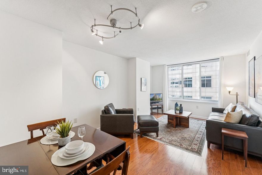 Welcome to Unit 718 at The Continental, one of Ballston’s most amenity rich and sought-after condos. This stylish one-bedroom offers a bright, open floorplan with tasteful finishes throughout. The kitchen features white cabinetry contrasted with beautiful black granite countertops, black appliances, and gas cooking. A breakfast bar opens into the spacious living space with a dedicated dining area and living room with large windows offering great natural light.

Beautiful oak hardwood floors extend from the main living space into the generously sized primary suite, which includes a large walk-in closet, a second closet for added storage, and access to a dual-entry bathroom with a tub/shower combo. The unit also comes with a convenient, dedicated garage parking space.

The Continental offers a wealth of upscale amenities, including a rooftop pool, a state-of-the-art rooftop fitness center, and a stunning top-floor community lounge. Additional perks include a lobby-level business center, theater room, and 24-hour concierge service. Located just steps from Ballston Quarter’s shops, dining, and entertainment and only three blocks from the Ballston Metro, this is Arlington living at its finest.